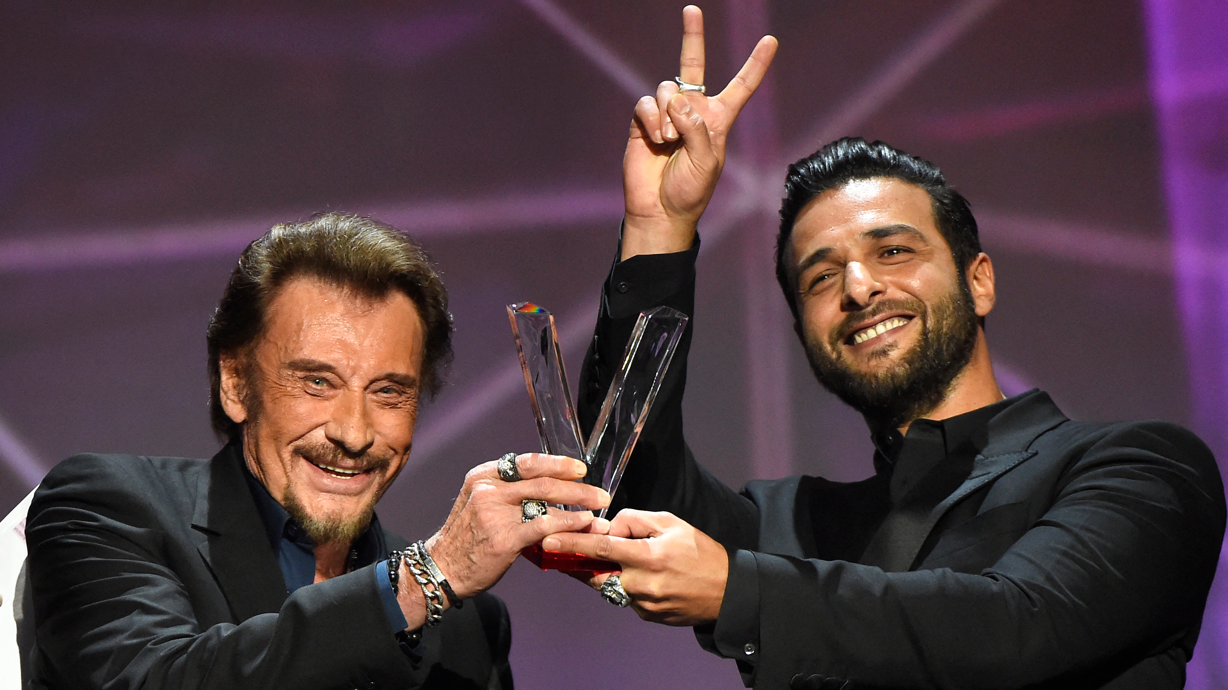 Hallyday receives the best album award composed by Yodelice (right) at the 31st Victoires de la Musique in France in 2016. /Bertrand Guay/AFP