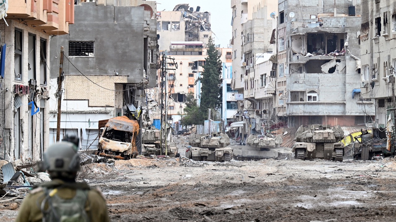 Israeli tanks roll along a street during a military operation in the northern Gaza Strip. /Ahikam Seri/AFP