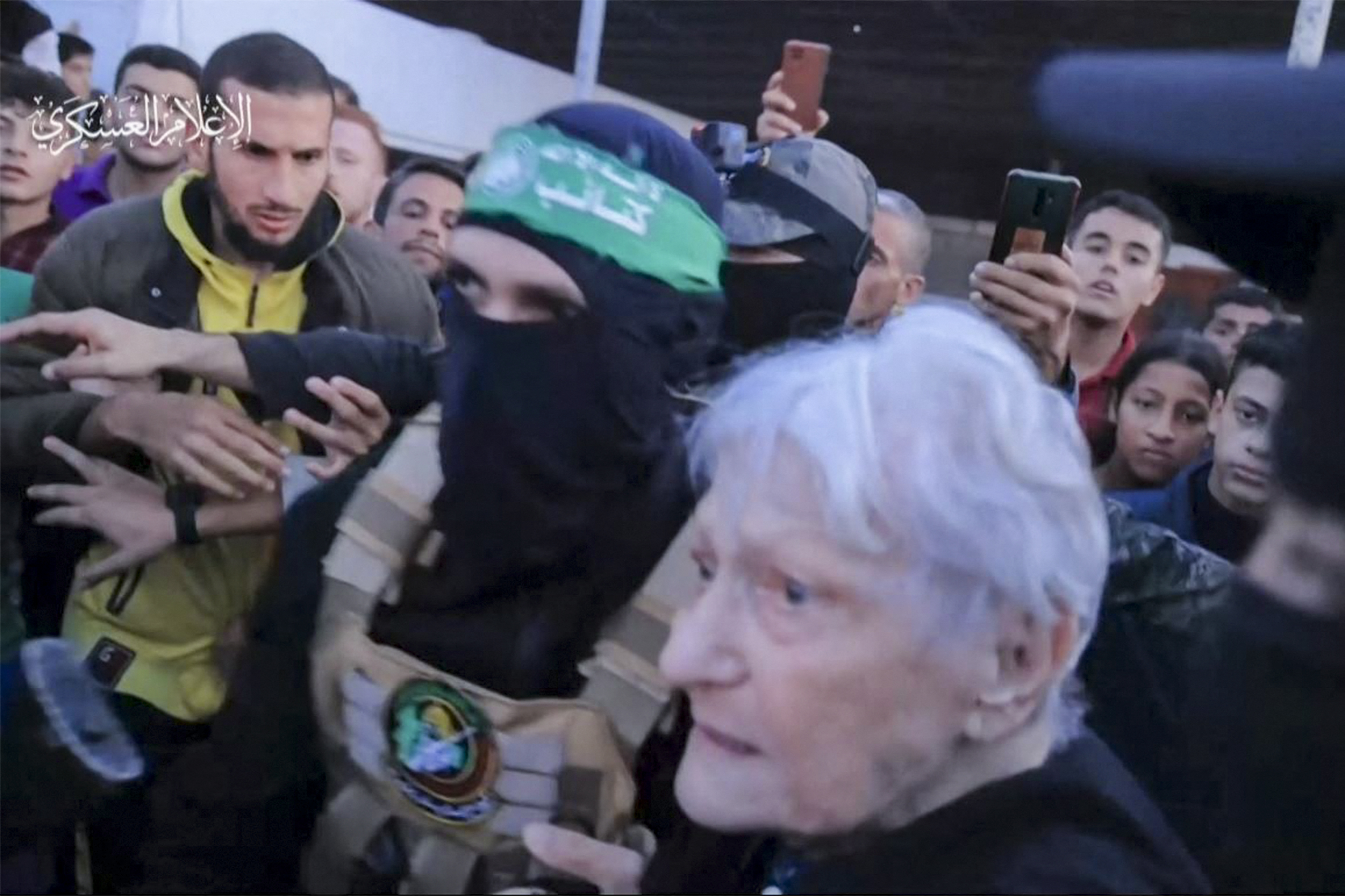 A hostage being handed over during the first day of the truce. /Hamas Media Office/AFP