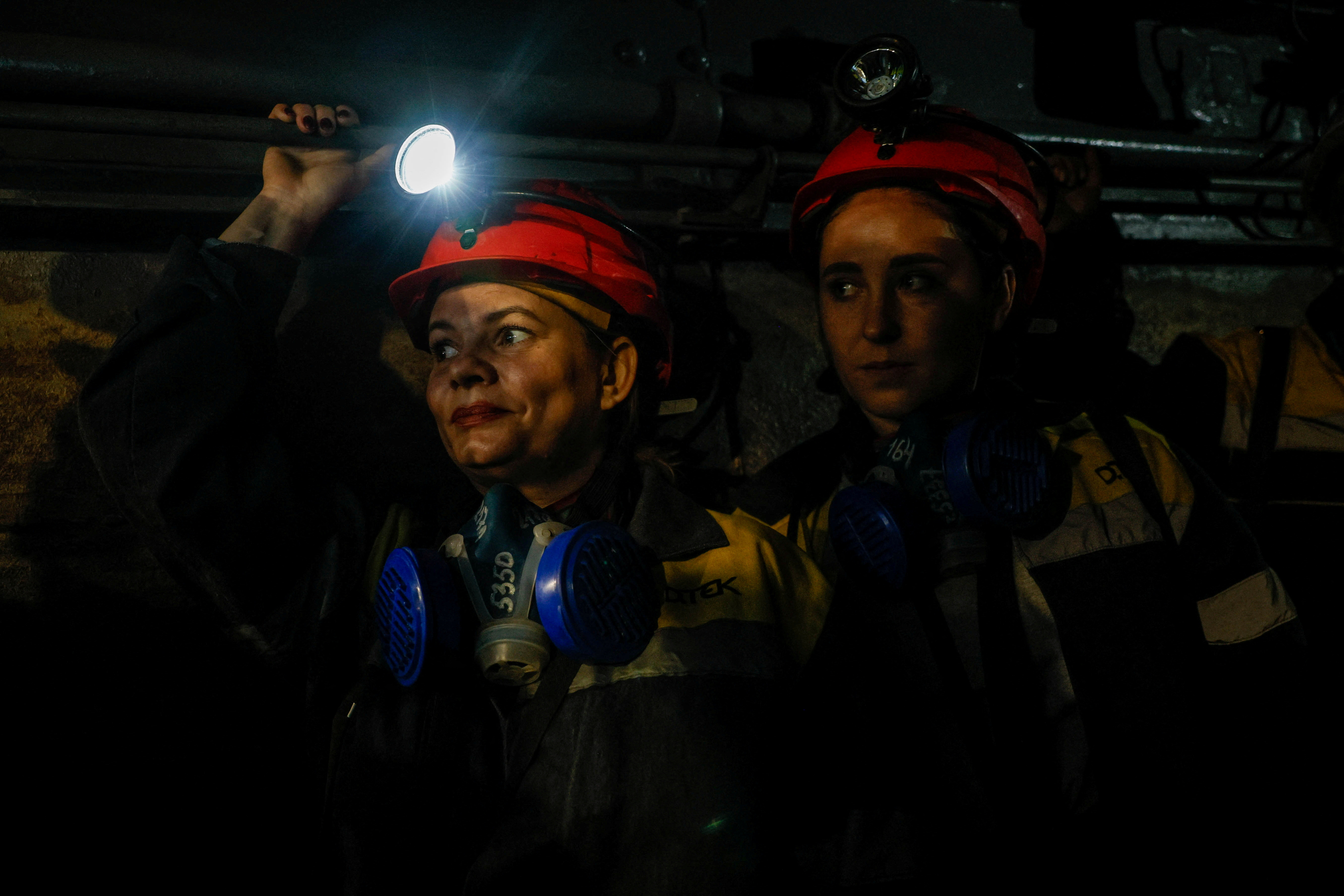 Nataliia, 43, and Krystyna, 22, go down in an elevator at the mine. /Alina Smutko/Reuters