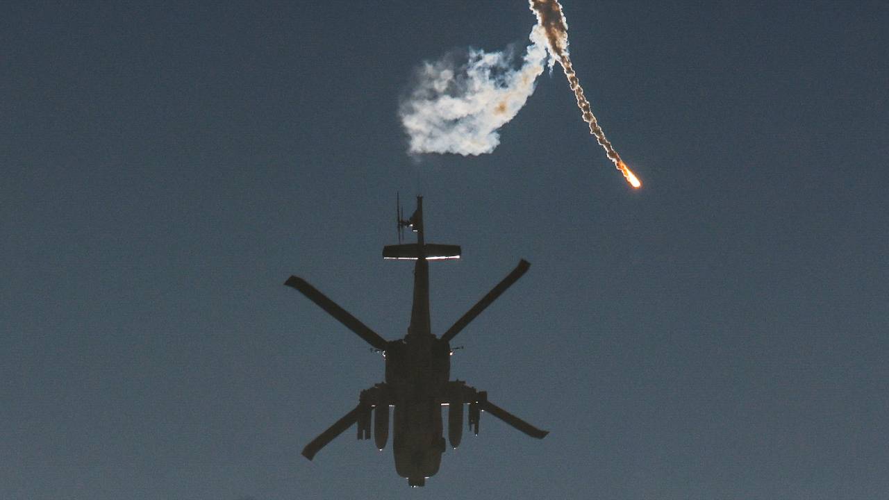 An Israeli military helicopter releases a flare over the Israel-Gaza border. /Amir Cohen/Reuters