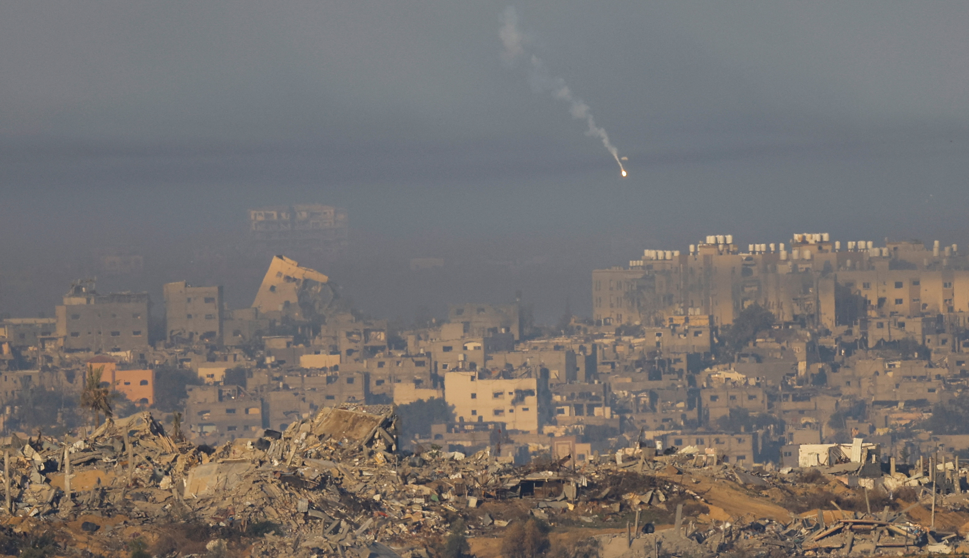 A flare falls over southern Gaza as the fighting between Israel and Hamas continues following a brief truce. /Reuters/Alexander Ermochenko.
