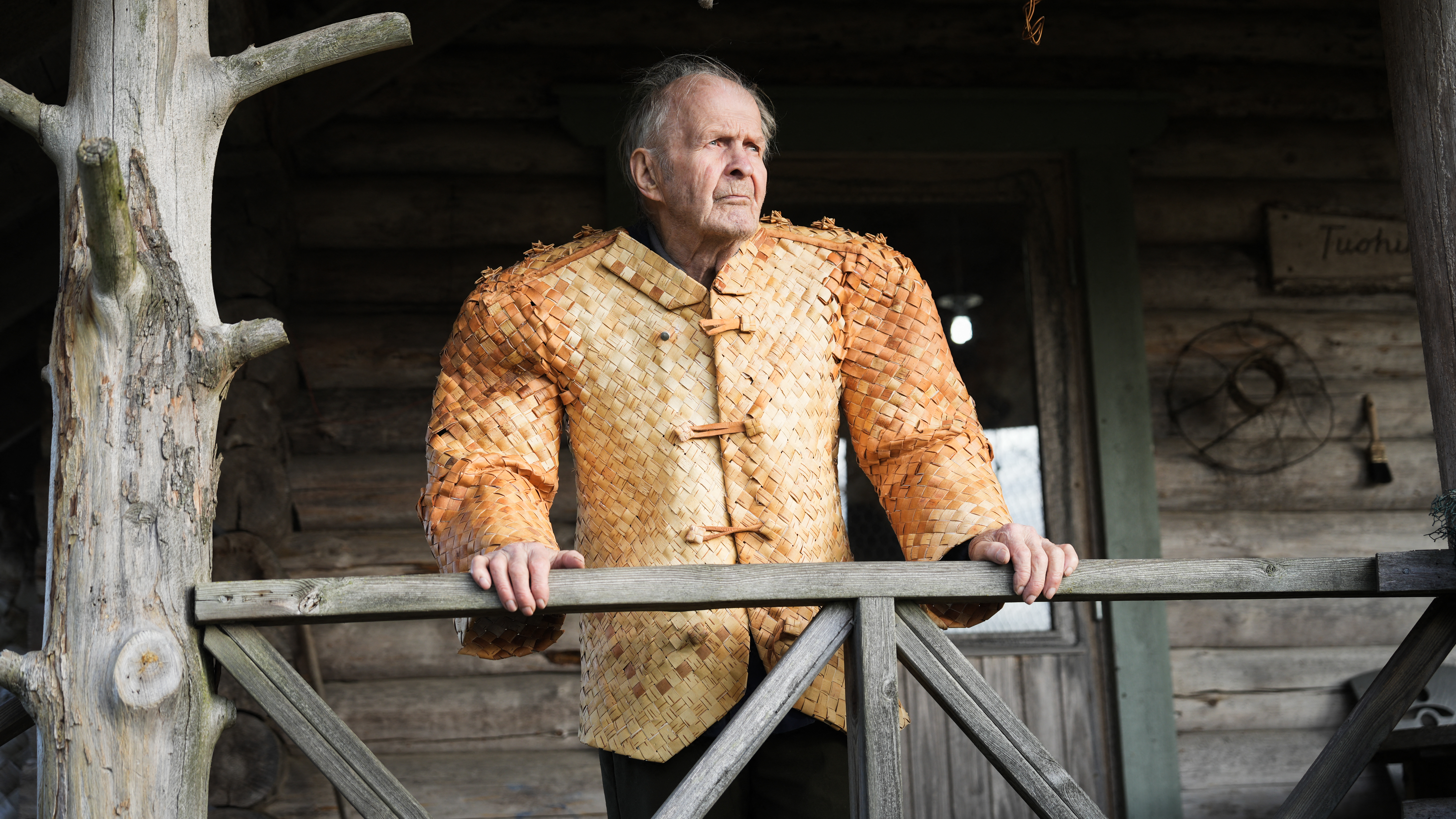 Erkki Pekkarinen poses wearing a jacket he made from birch tree bark in front of his shop in Asikkala, Finland. /Alessandro Rampazzo/AFP