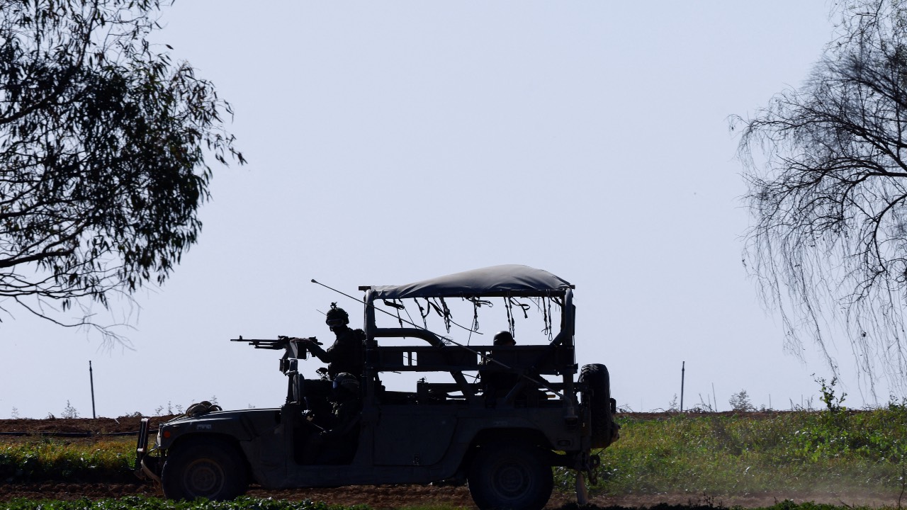 Israeli soldiers drive near Gaza in southern Israel. /Clodagh Kilcoyne/Reuters