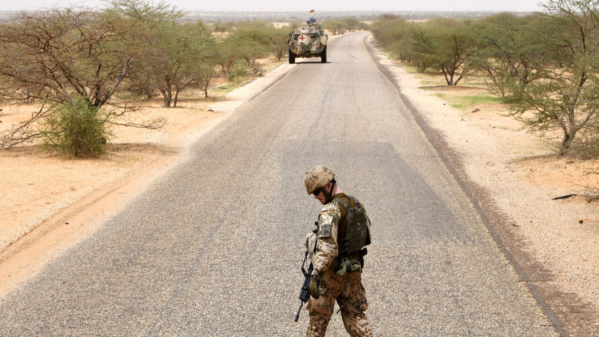 A German soldier from the parachutists detachment of the MINUSMA searches for explosives during a patrol on the route from Gao to Gossi, Mali. /Seyllou/AFP
