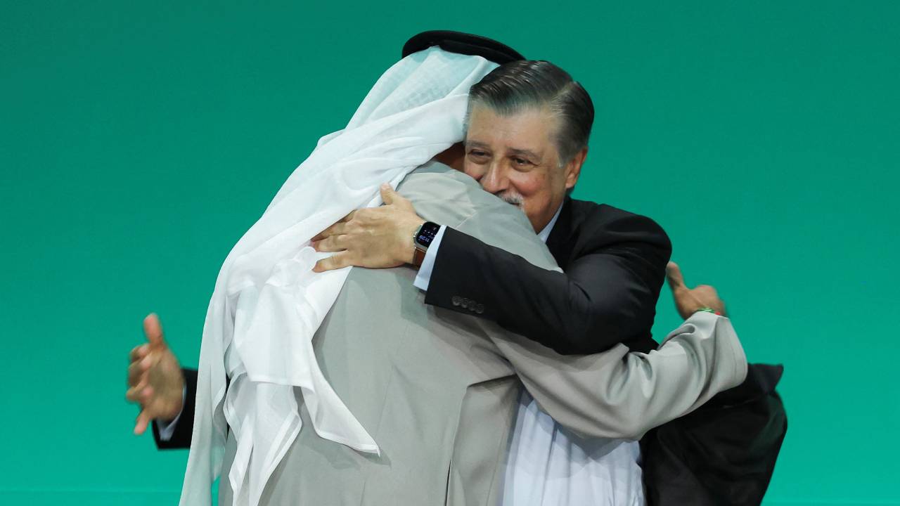 United Arab Emirates Minister of Industry and Advanced Technology and COP28 President Sultan Ahmed Al Jaber hugs COP28 Chief Executive Officer Adnan Amin after the draft deal was released. /Amr Alfiky/Reuters