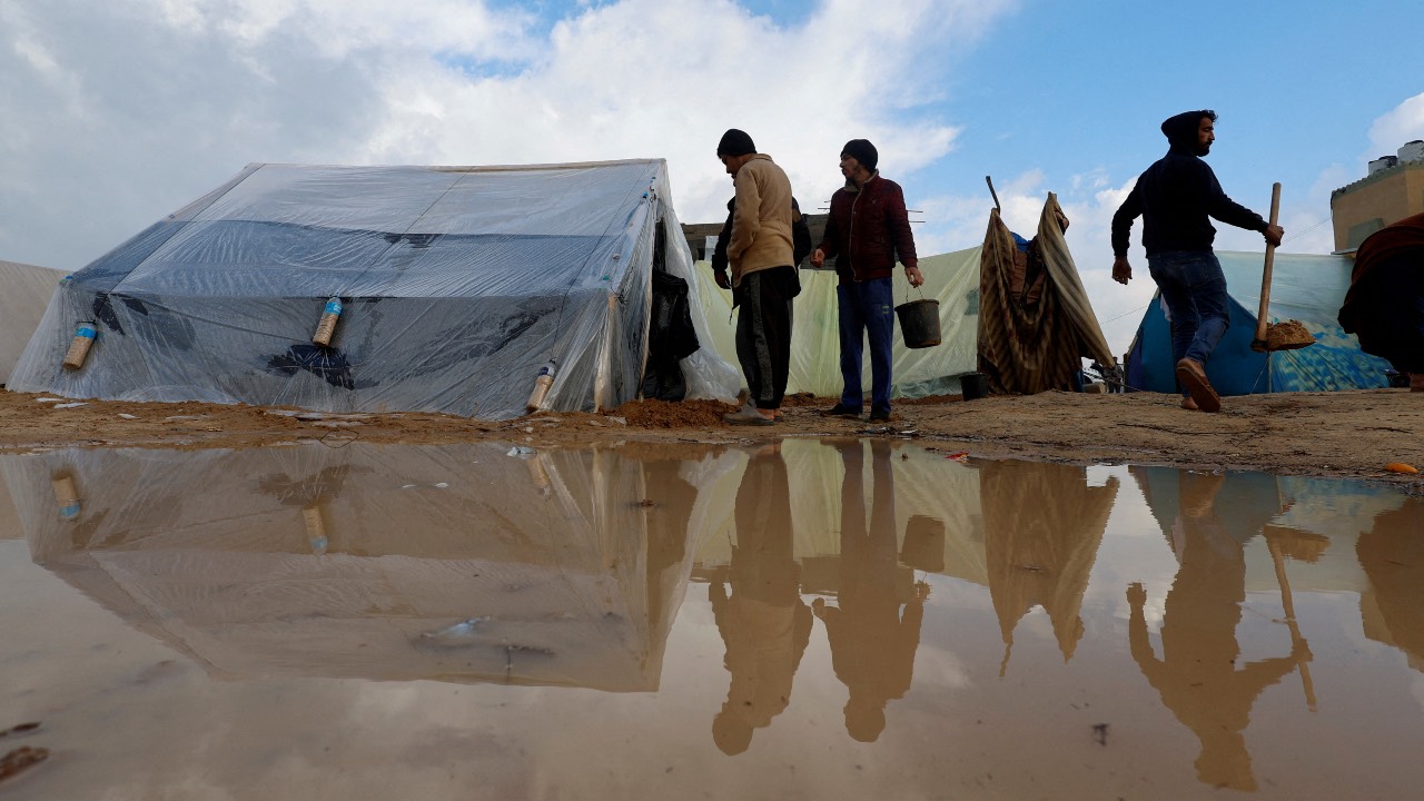Displaced Palestinians inspect their tents following heavy rains at refugee camps in Rafah, in the southern Gaza Strip. /Mohammed Salem/Reuters