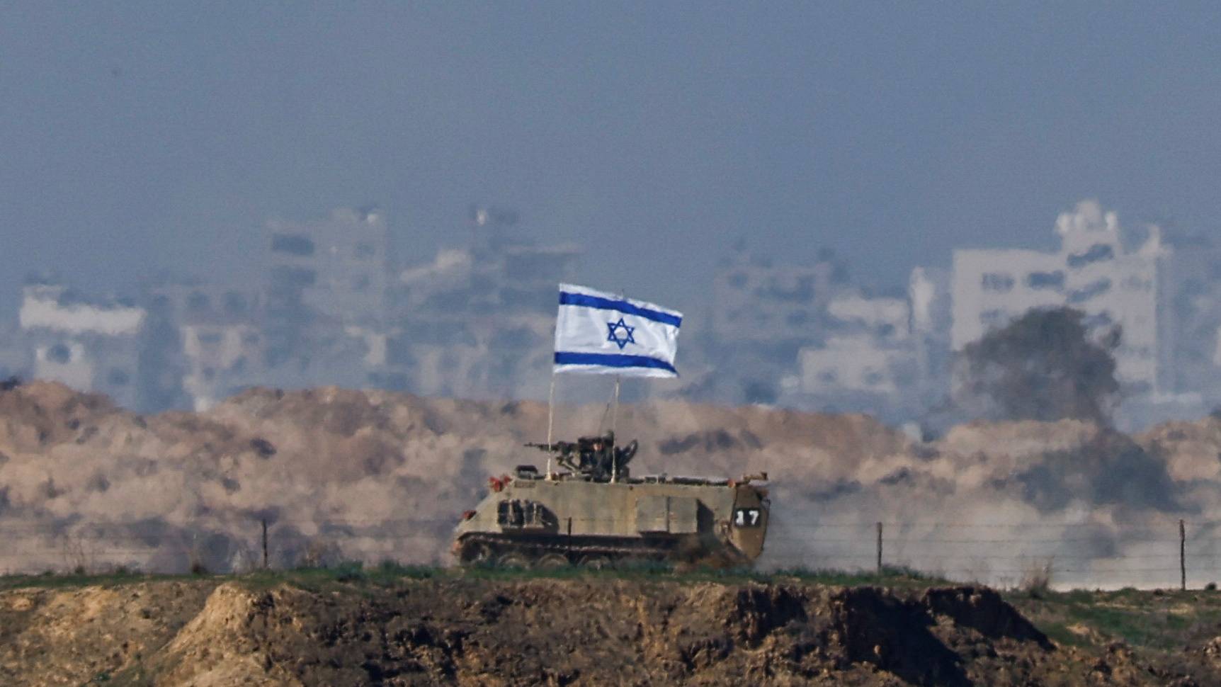 An Israeli military vehicle drives along the border with Gaza. /Clodagh Kilcoyne/Reuters