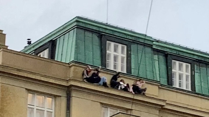 People watch from a roof following a shooting at one of the buildings of Charles University. Ivo Havranek/via Reuters