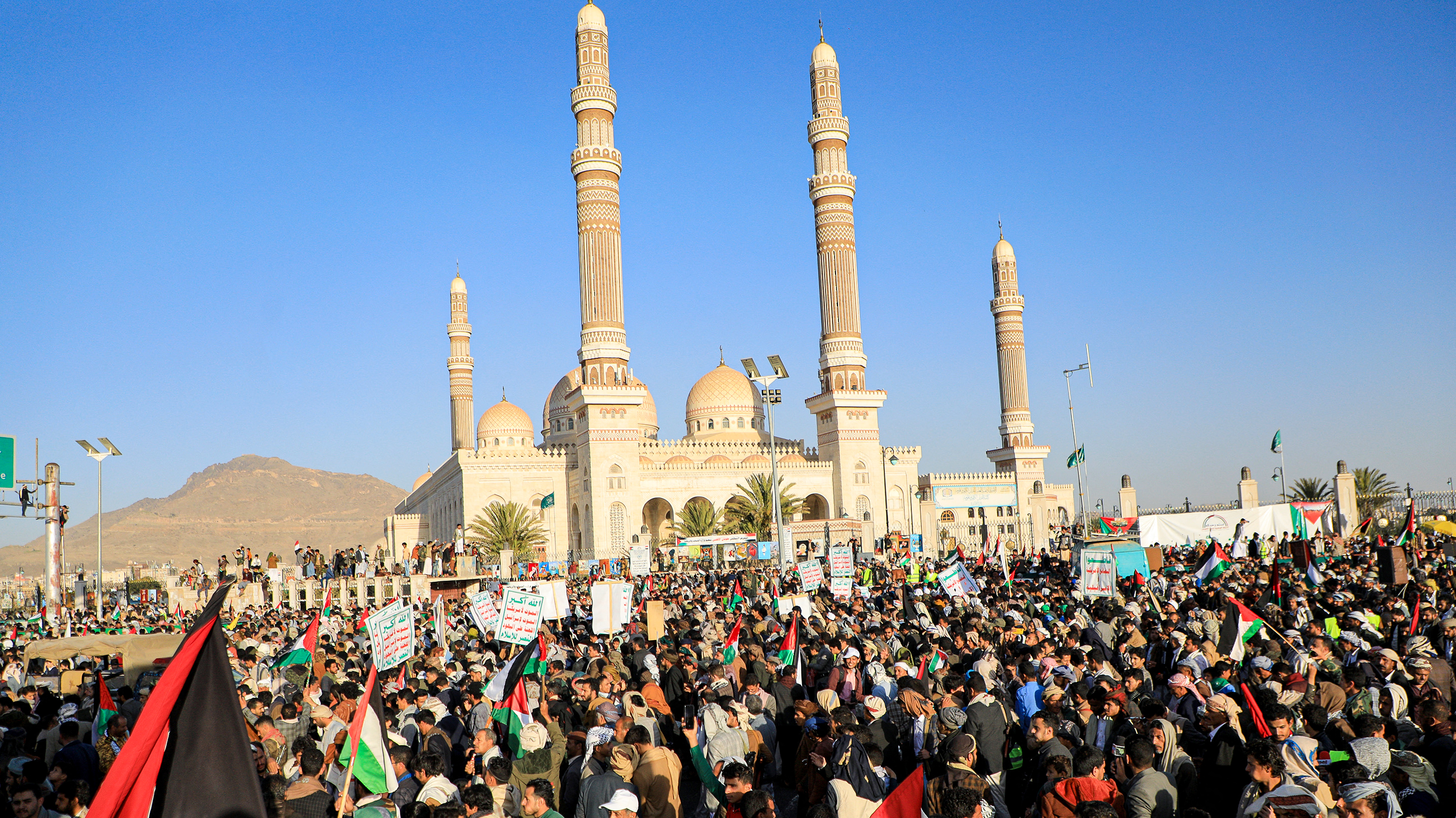 Yemenis hold signs and Palestinian flags during a march in solidarity with the people of Gaza in the Huthi-controlled capital Sanaa. / Israel Defense Forces/Handout via Reuters