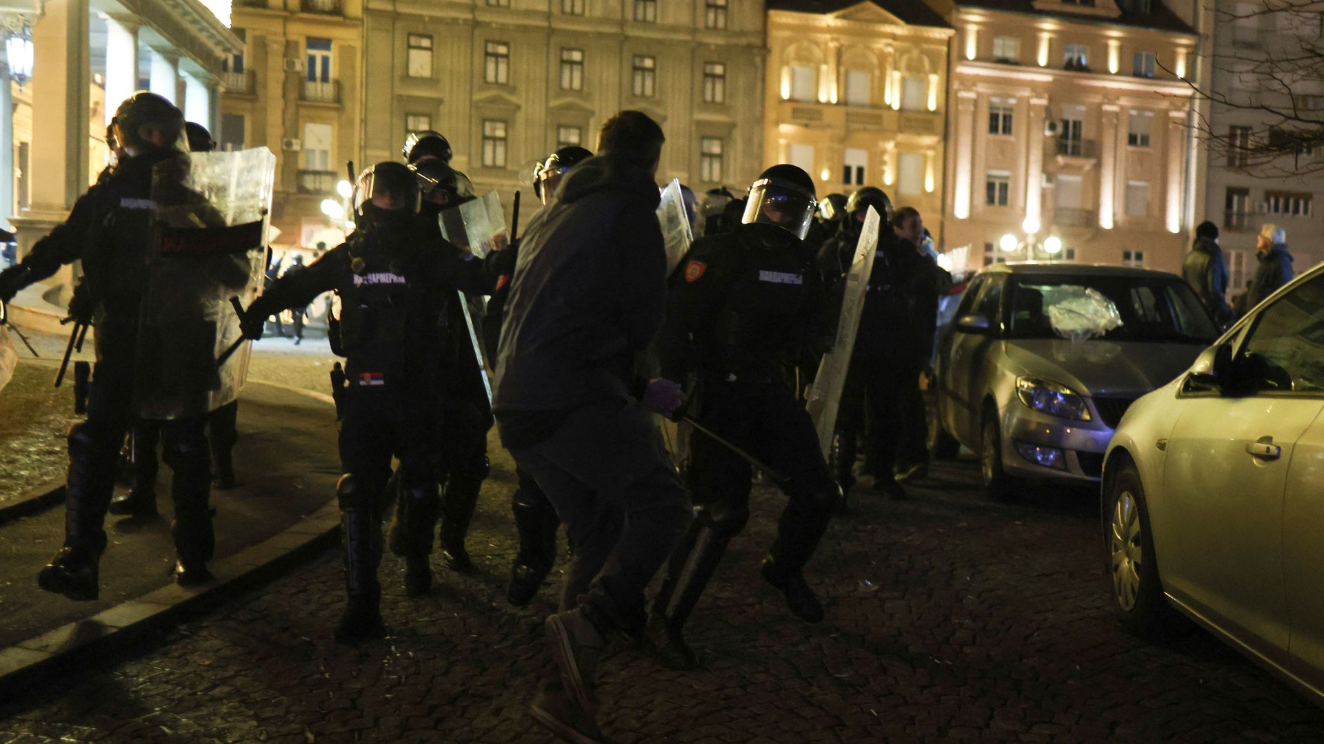 Police officers take position outside Belgrade city hall during a protest on Sunday. /Marko Djurica/Reuters