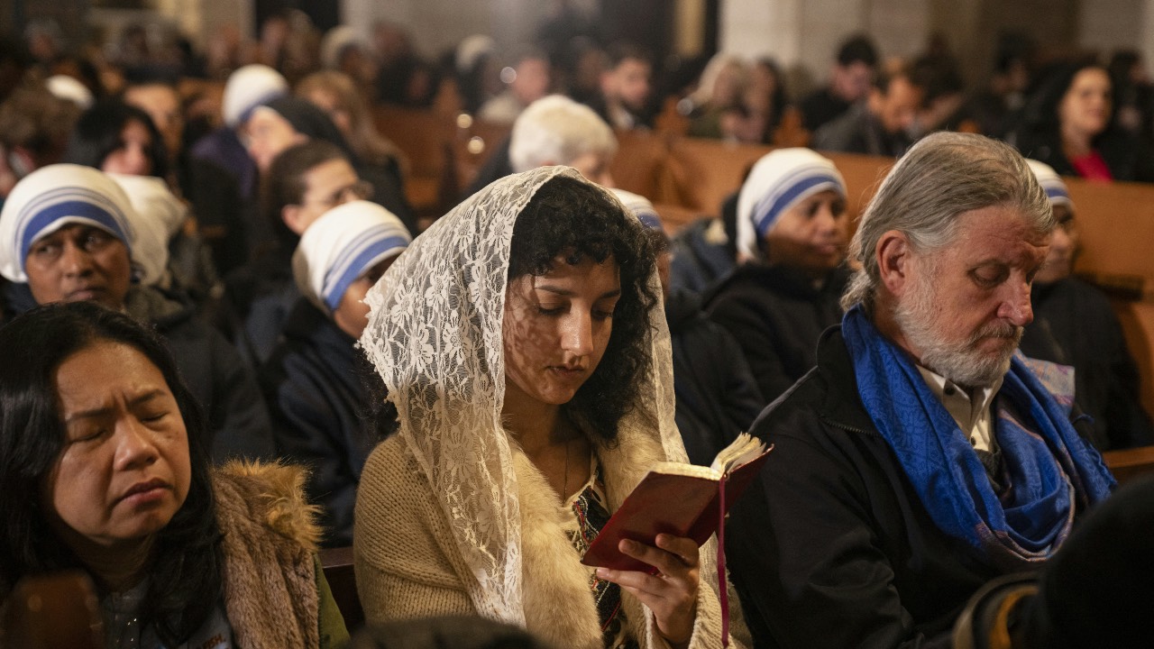 Worshippers attend the Christmas midnight Mass at the Church of the Nativity compound in the biblical city of Bethlehem in the occupied West Bank. /Nasser Nasser/AFP