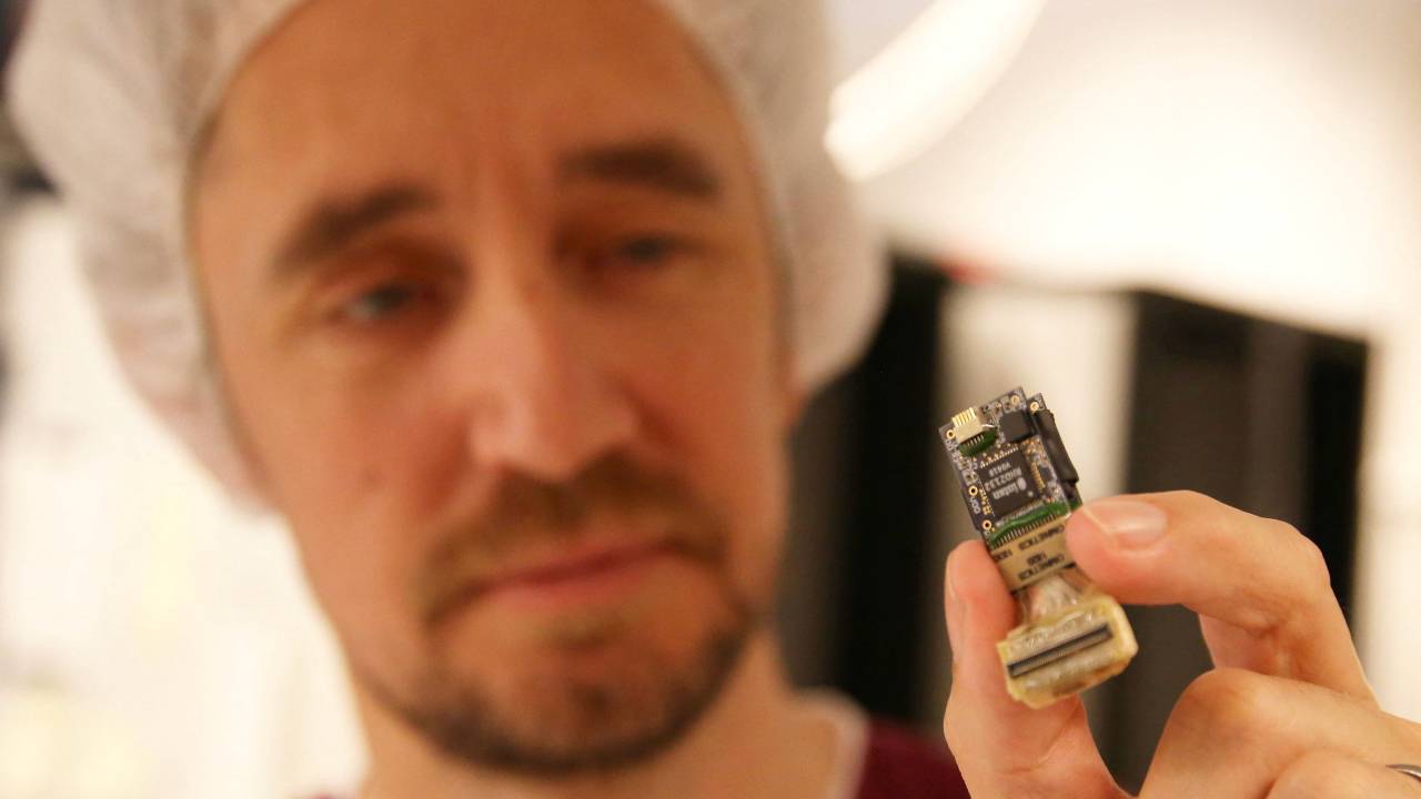 Par Halje holds up one of the electrodes inserted into rats' brains to measure the effects of psychedelics on brain activity, at Lund University. /Tom Little/Reuters