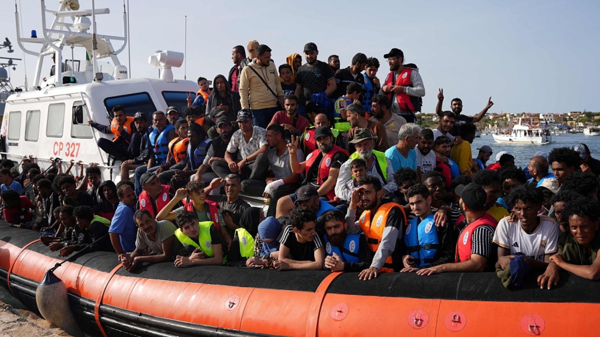 Immigrants arrive on a packed boat in Lampedusa in September. /Zakaria Abdelkafi/CFP