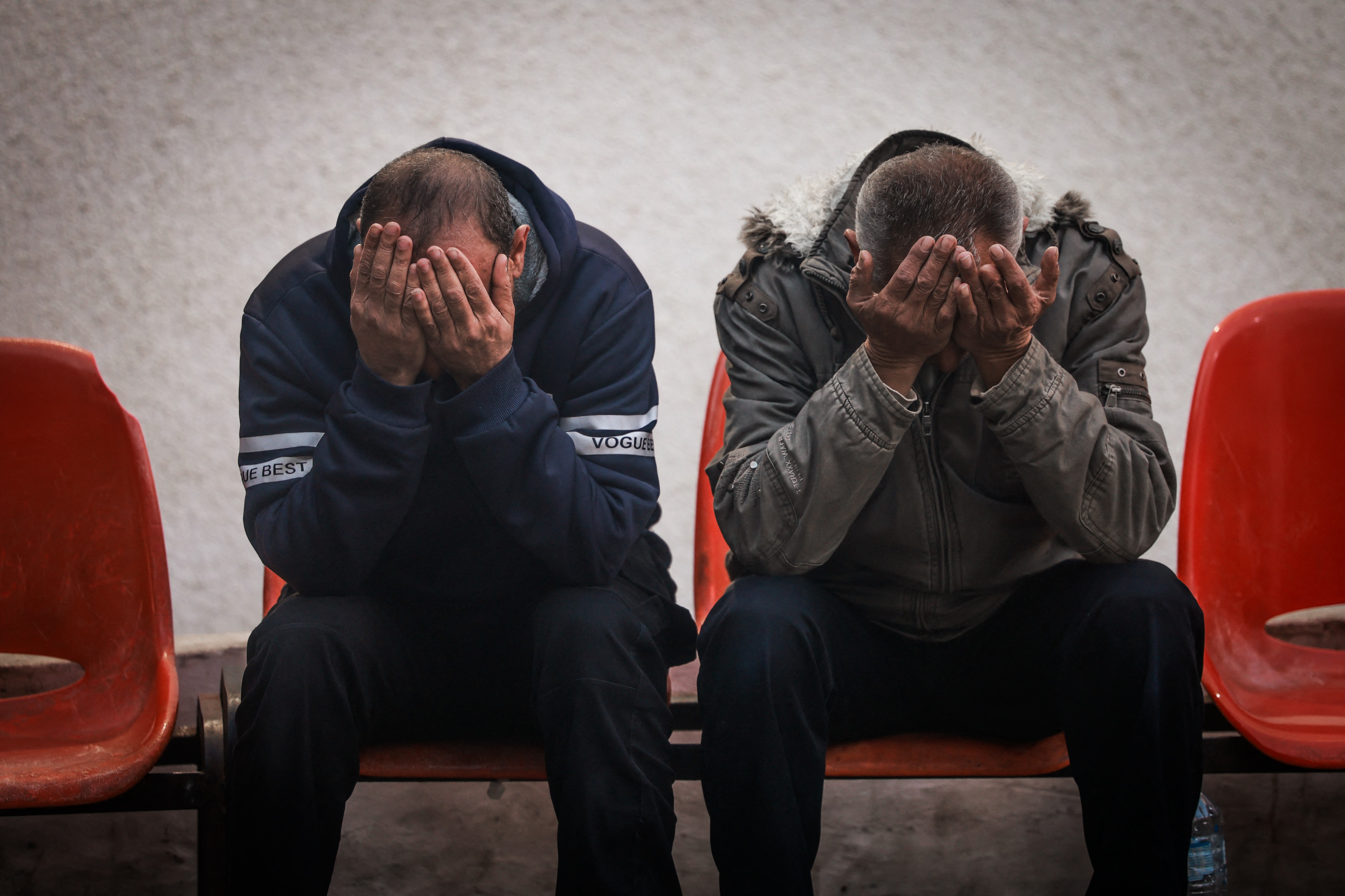 Two Palestinians mourn the loss of loved ones killed in Rafah, a border city near Egypt. /AFP