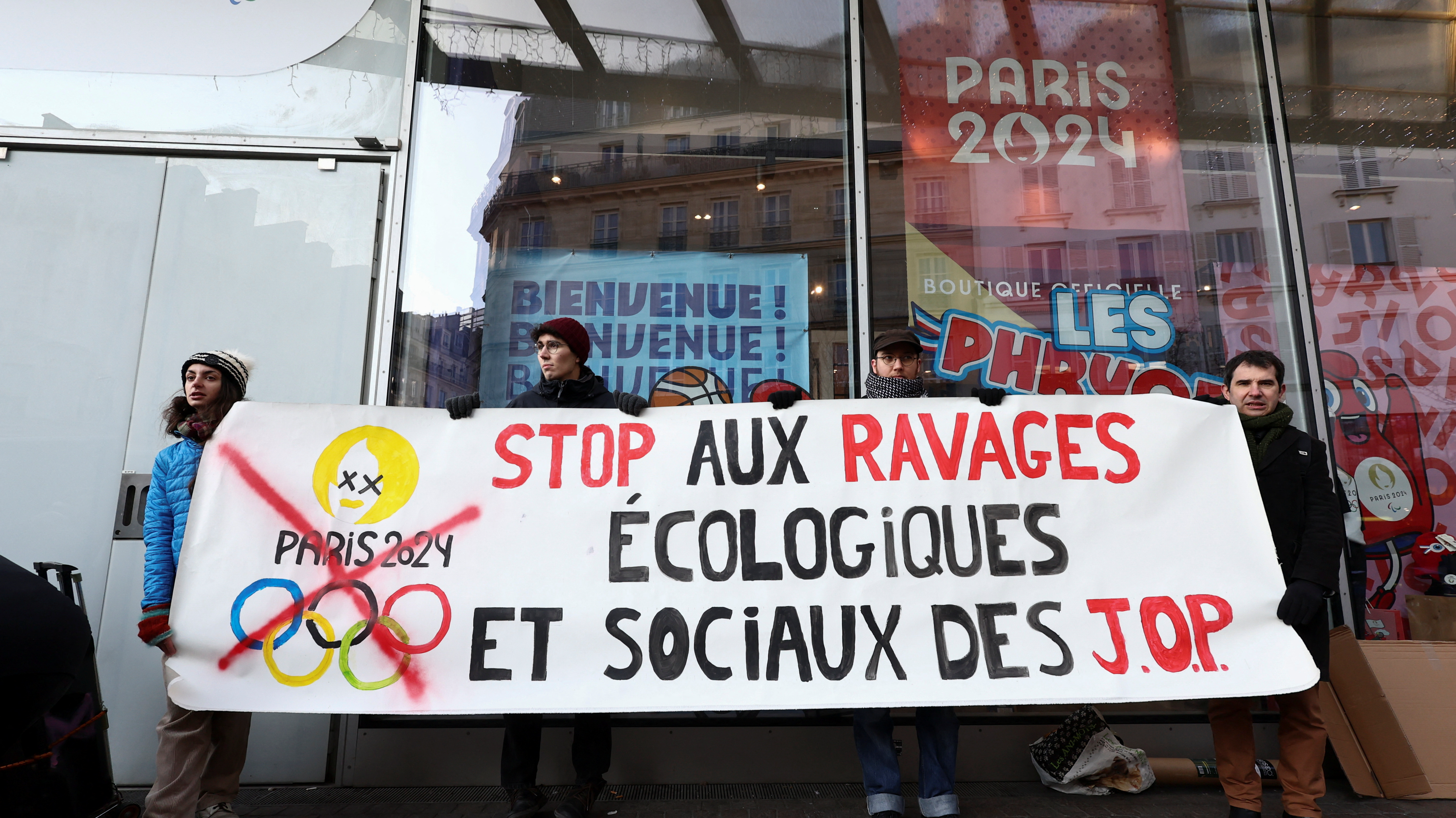 Environmental activists stage a 'die-in' protest in Paris earlier this month and hold a banner reading, 'Stop the ecological and social devastation of the Olympics'. /Stephanie Lecocq/Reuters