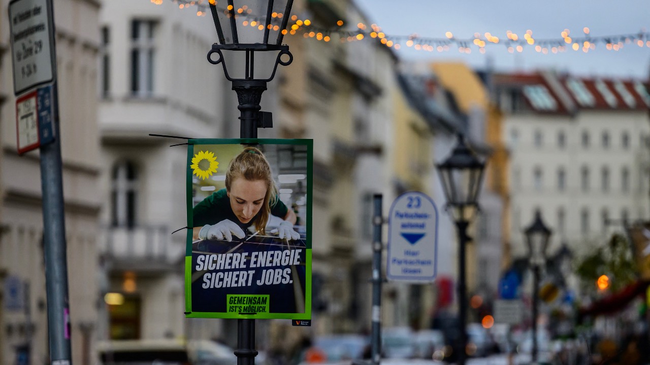 An election placard for Germany's Green Party reads 'Secure energy secures jobs,' displayed in Berlin. /John Macdougall/AFP