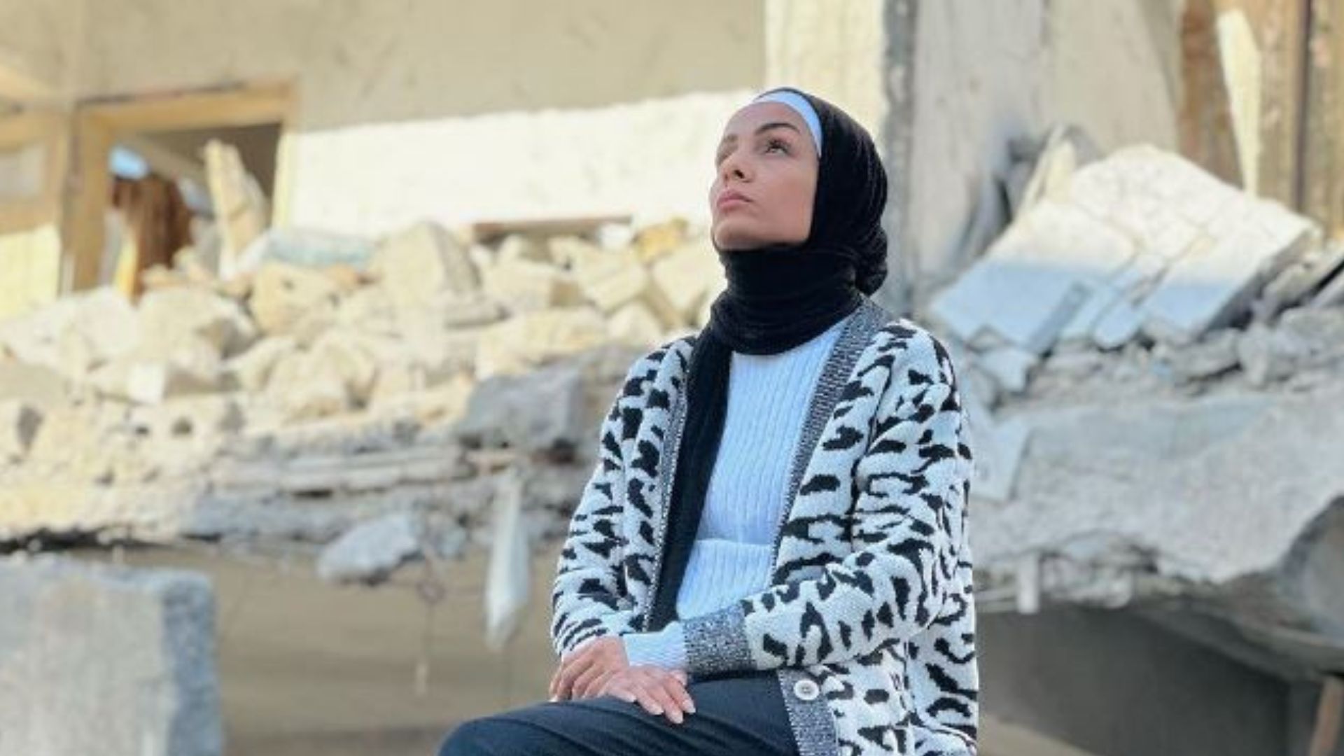 CGTN correspondent Noor Harazeen sits among the rubble in Gaza, December 2023. /CGTN