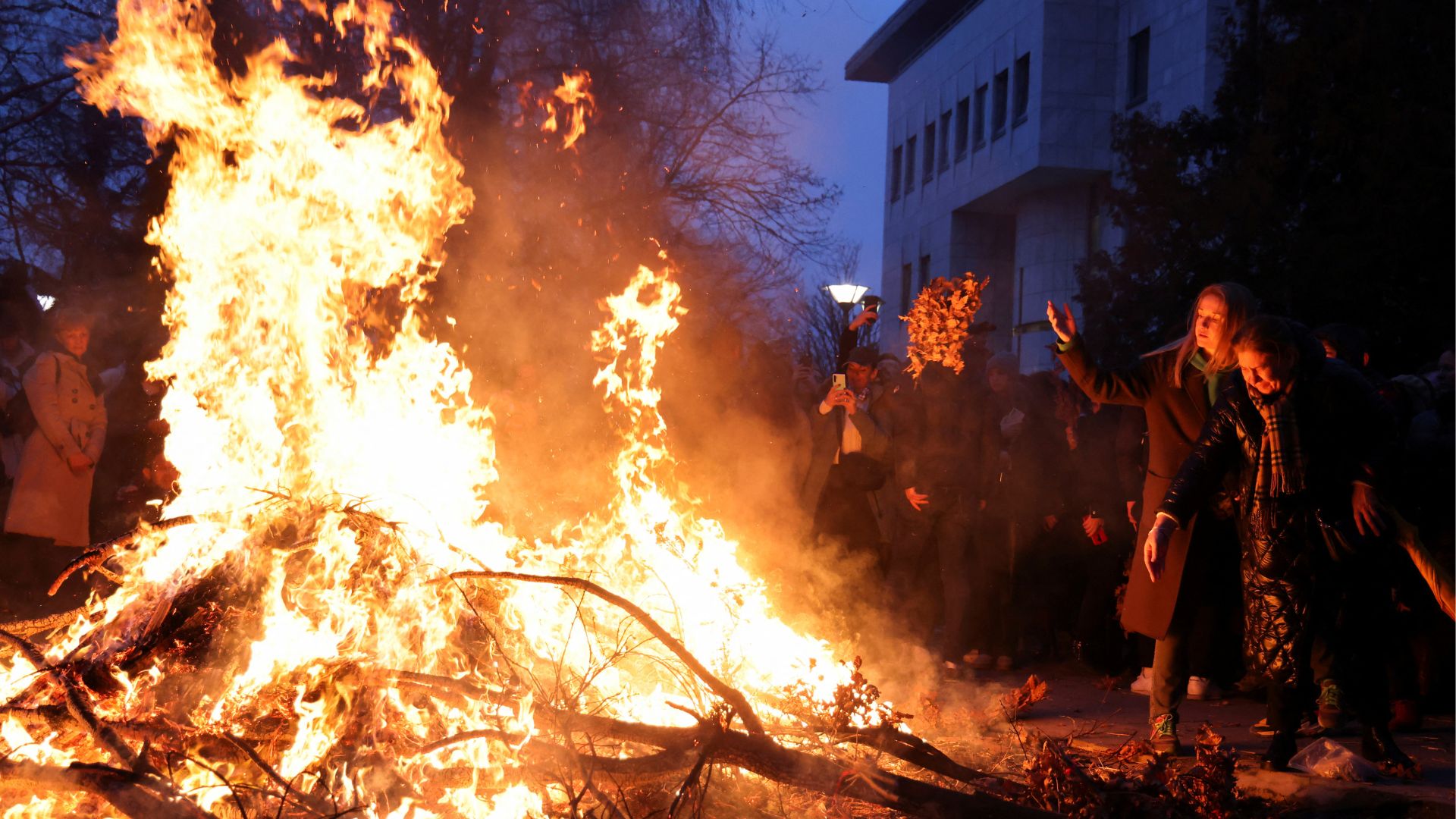 Orthodox Christians burn dried oak branches as they celebrate Christmas Eve in Belgrade, Serbia. /Zorana Jevtic/Reuters