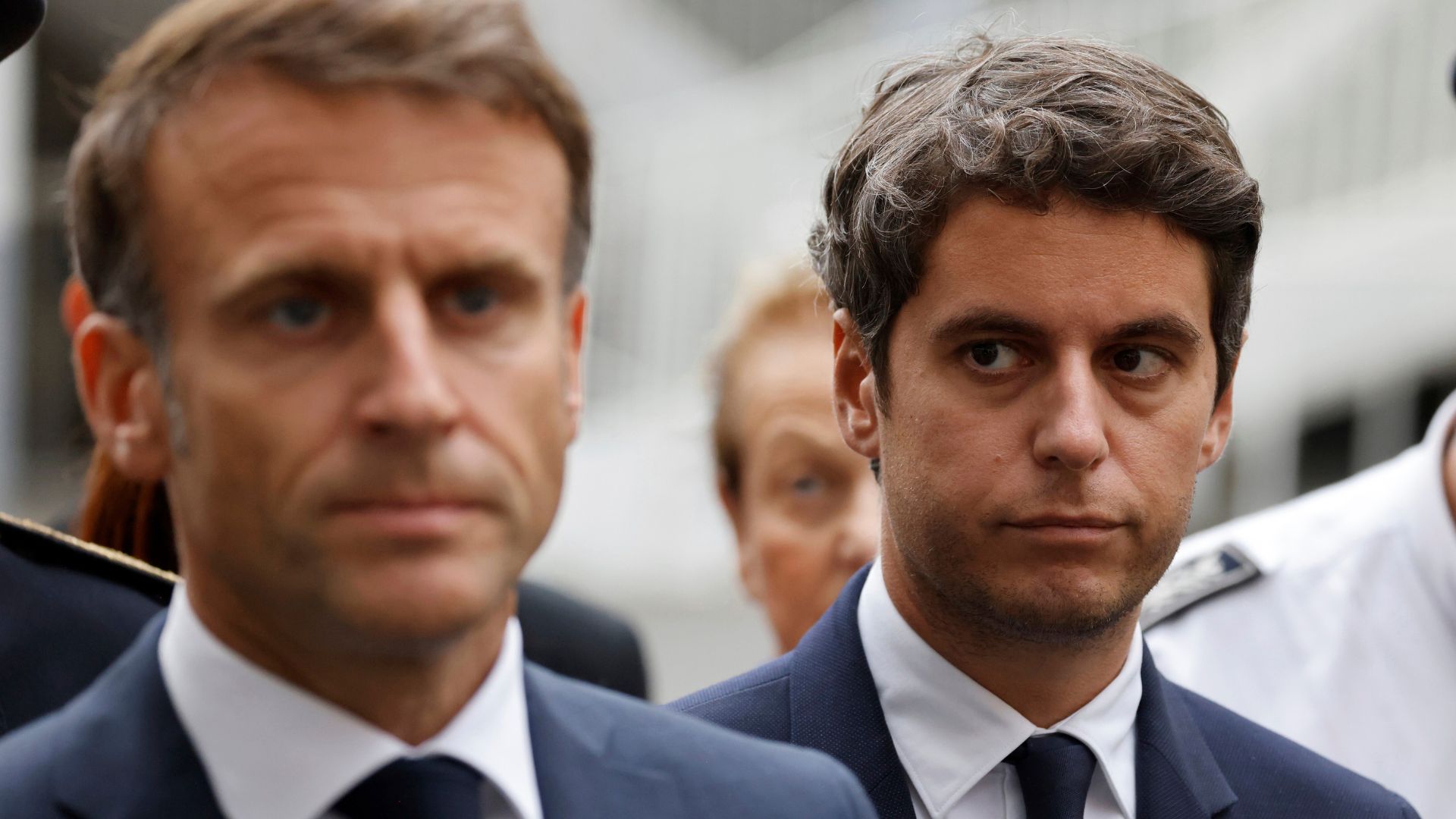 Then French Education and Youth Minister Gabriel Attal watches French President Emmanuel Macron talking to the press at the Gambetta high school in Arras, northeastern France. /Ludovic Marin/AP