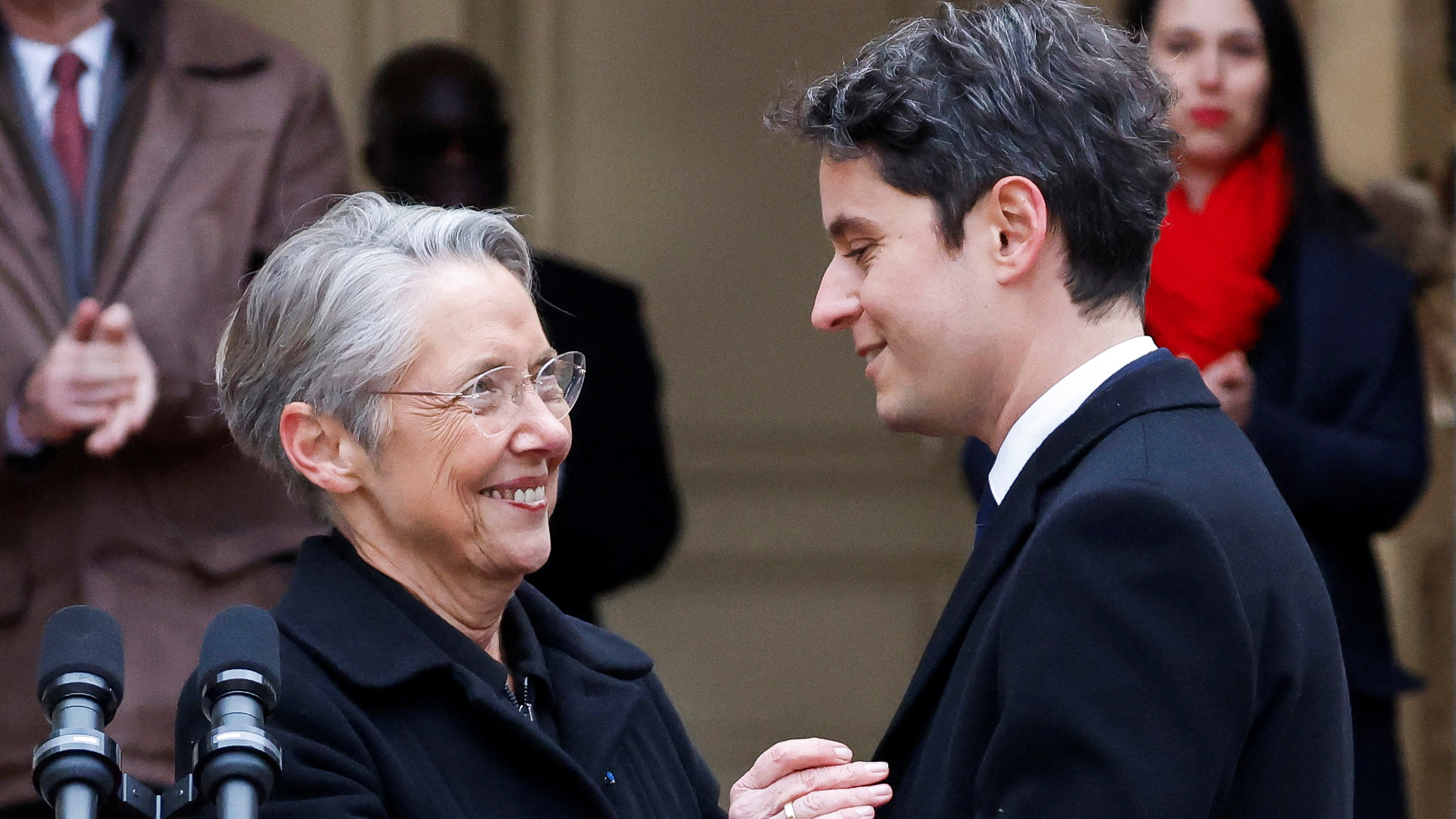 Outgoing Prime Minister Elisabeth Borne greets her successor Gabriel Attal. /Ludovic Marin/Reuters