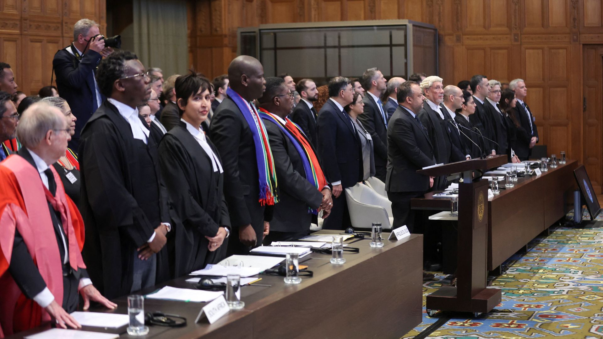 South Africa's Minister of Justice Ronald Lamola, lawyer Adela Hassim and the delegation stand as judges at the ICJ. /Thilo Schmuelgen/Reuters