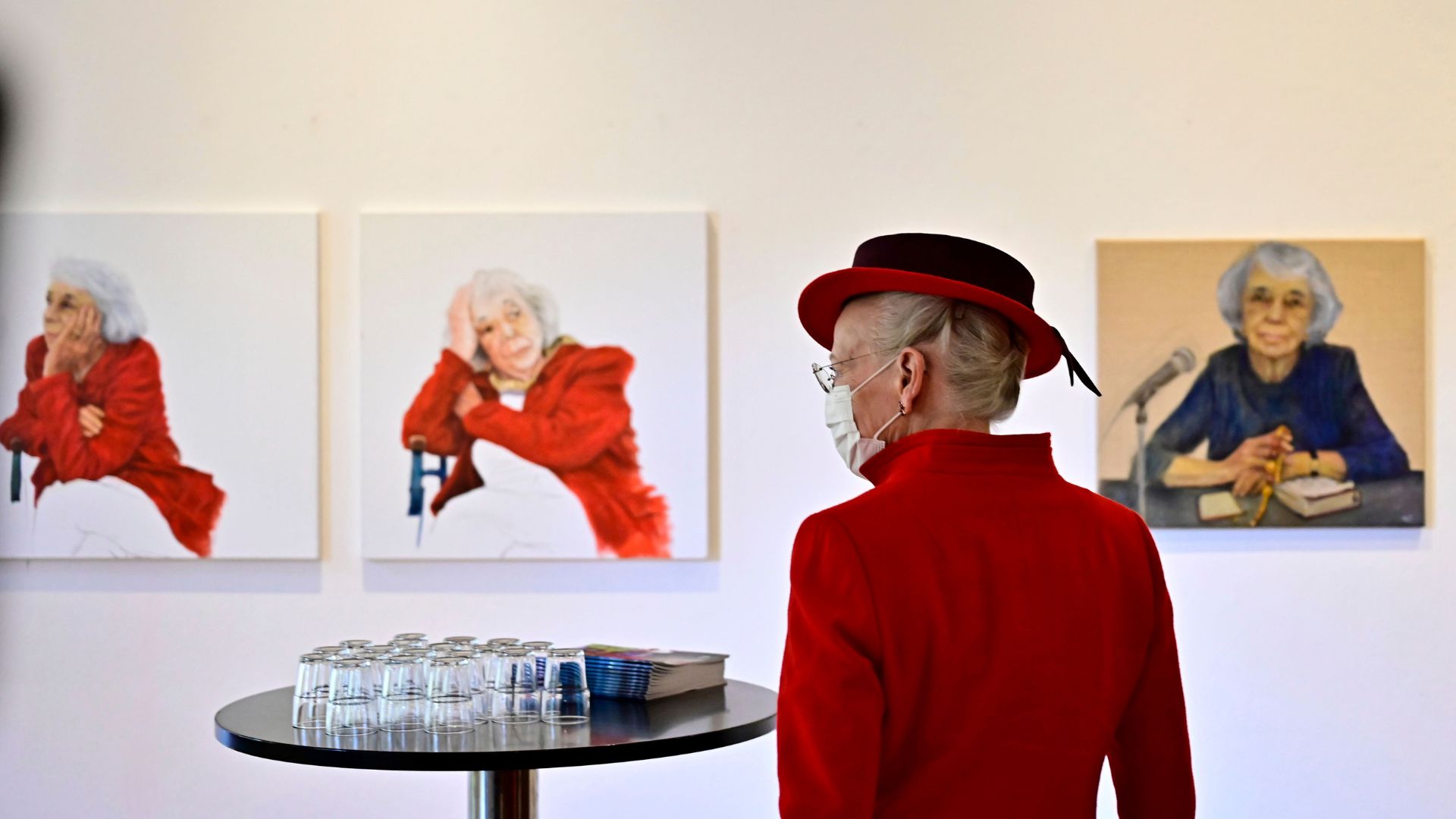 Queen Margrethe II of Denmark looks at portraits of German Holocaust survivor Margot Friedlander by artist Stephanie v. Dallwitz at the Literaturhaus in Berlin. /Tobias Schwarz/AP