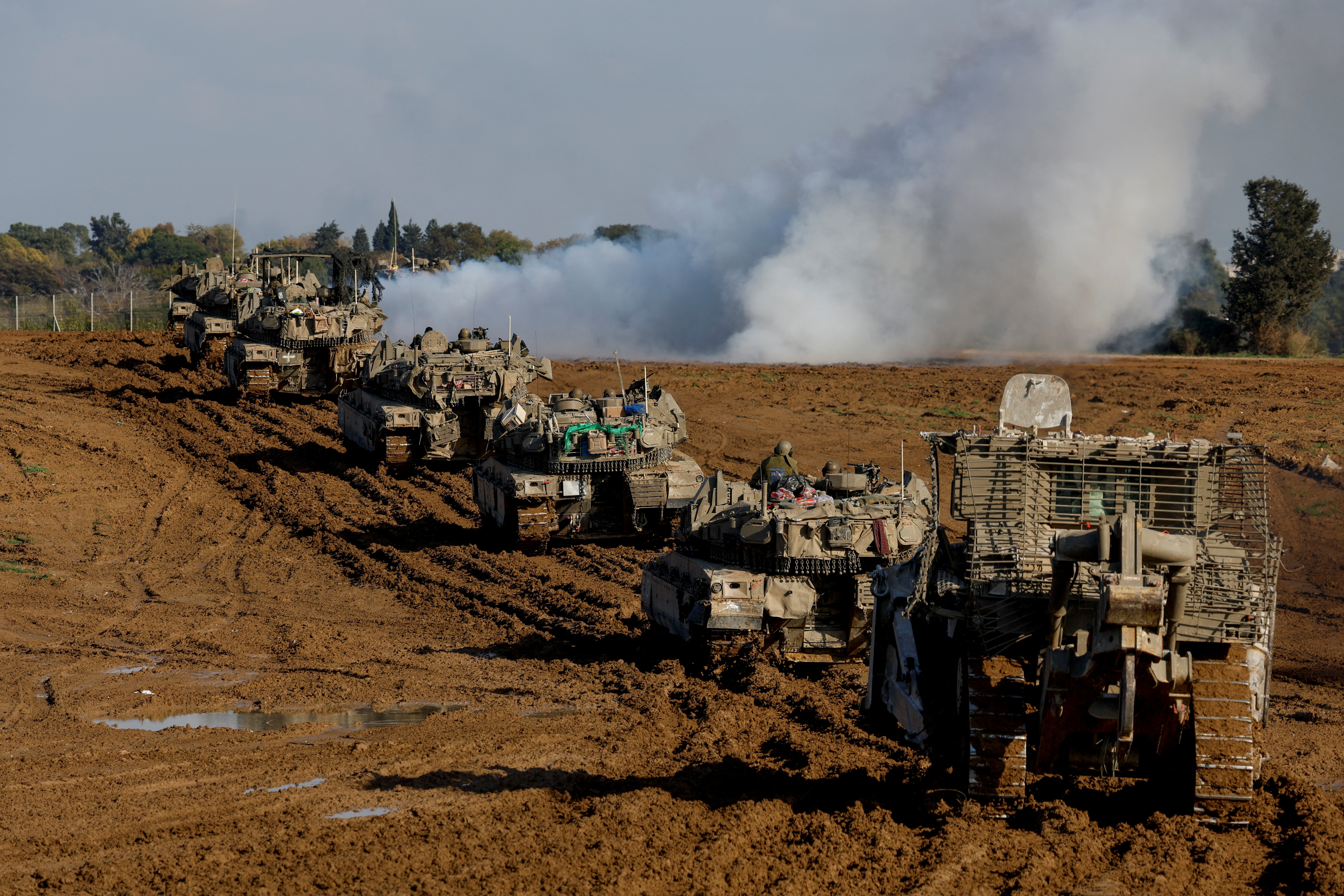 Israeli military vehicles are seen moving out of the Gaza Strip. But while Israel is withdrawing some soldiers, its bombardment of Gaza continues./Reuters/Amir Cohen.
