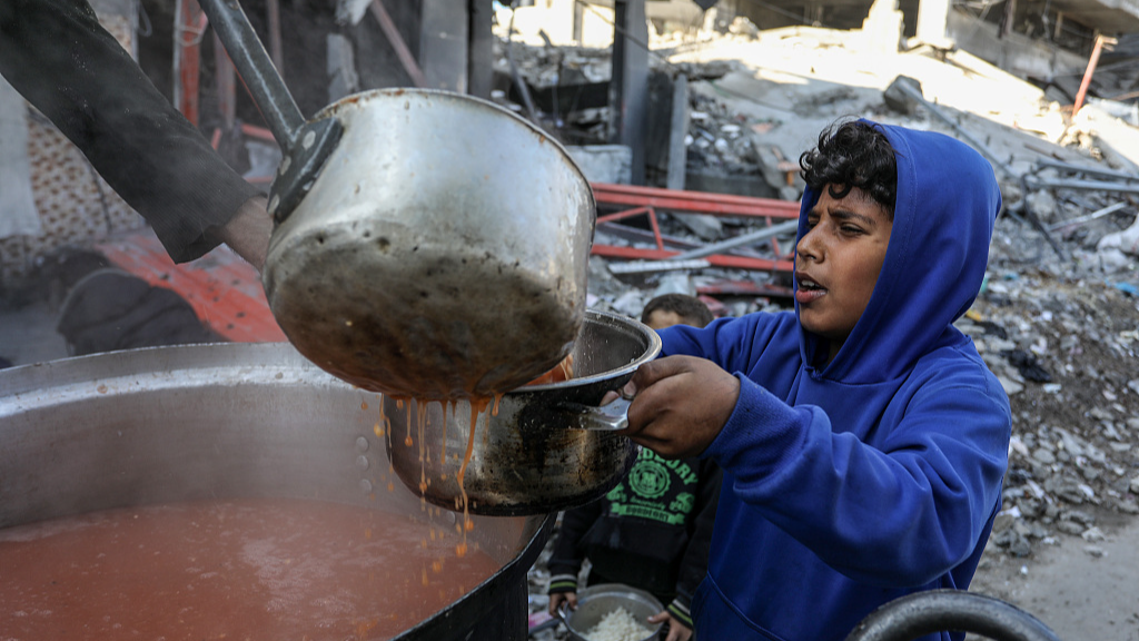 A child lines up for soup from volunteers in Rafah Gaza /Abed Rahim Khatib/Getty via CFP