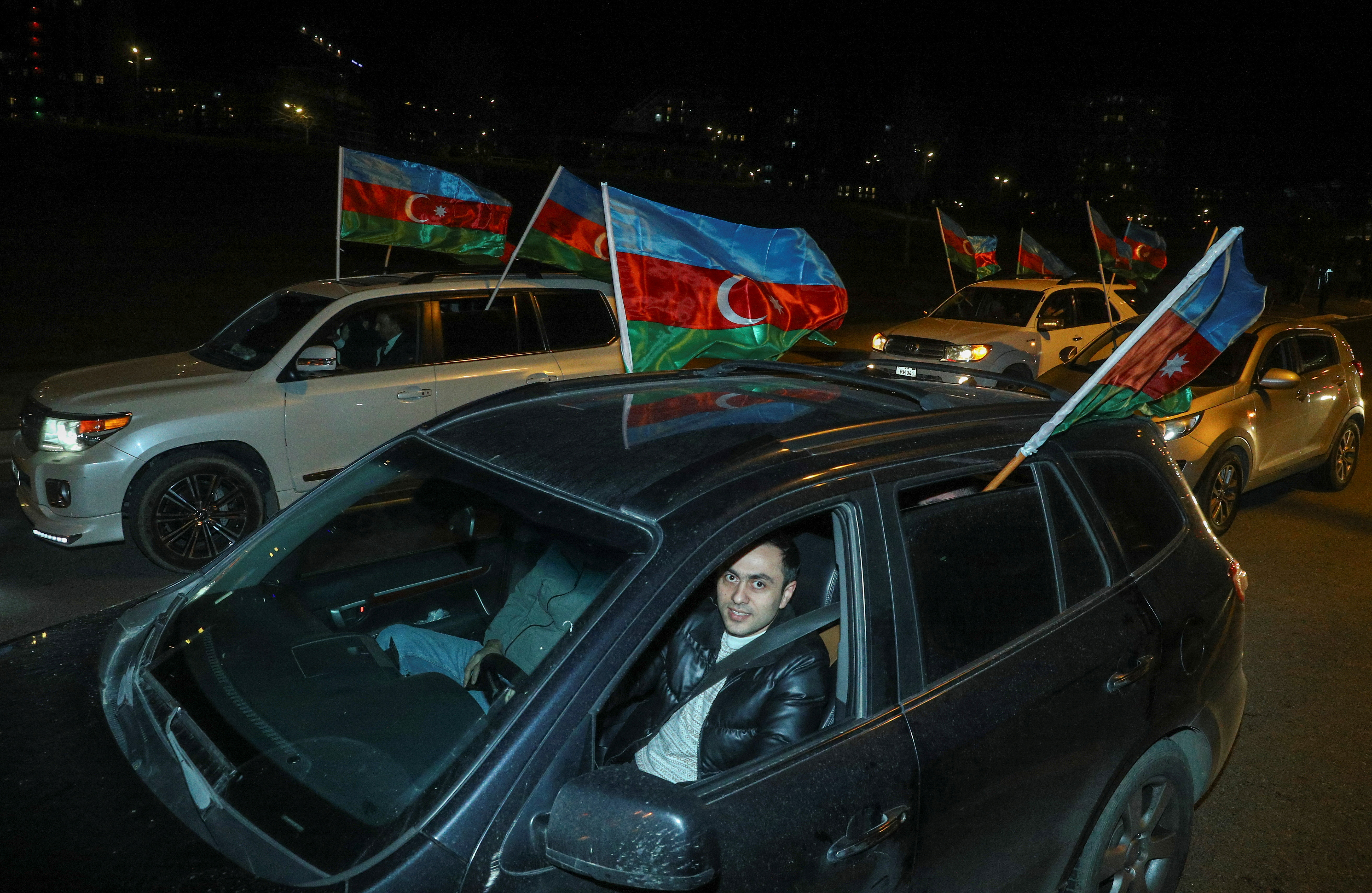 People take part in a motor rally following the announcement of exit poll results of the presidential elections in Baku, Azerbaijan, February 7, 2024. REUTERS/Aziz Karimov