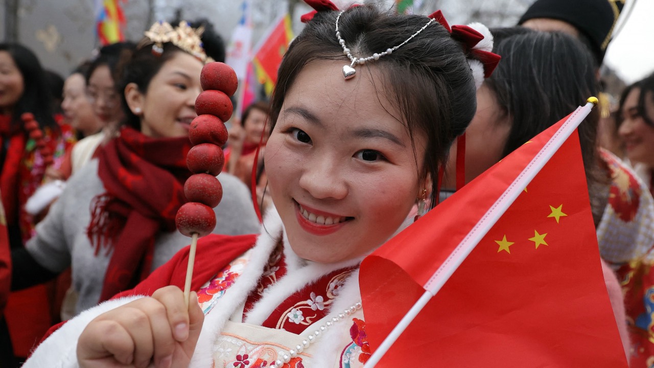 A member of the Chinese community takes part in a parade to celebrate the Chinese Lunar New Year on the Champs-Elysees in Paris. /Thomas Samson/AFP