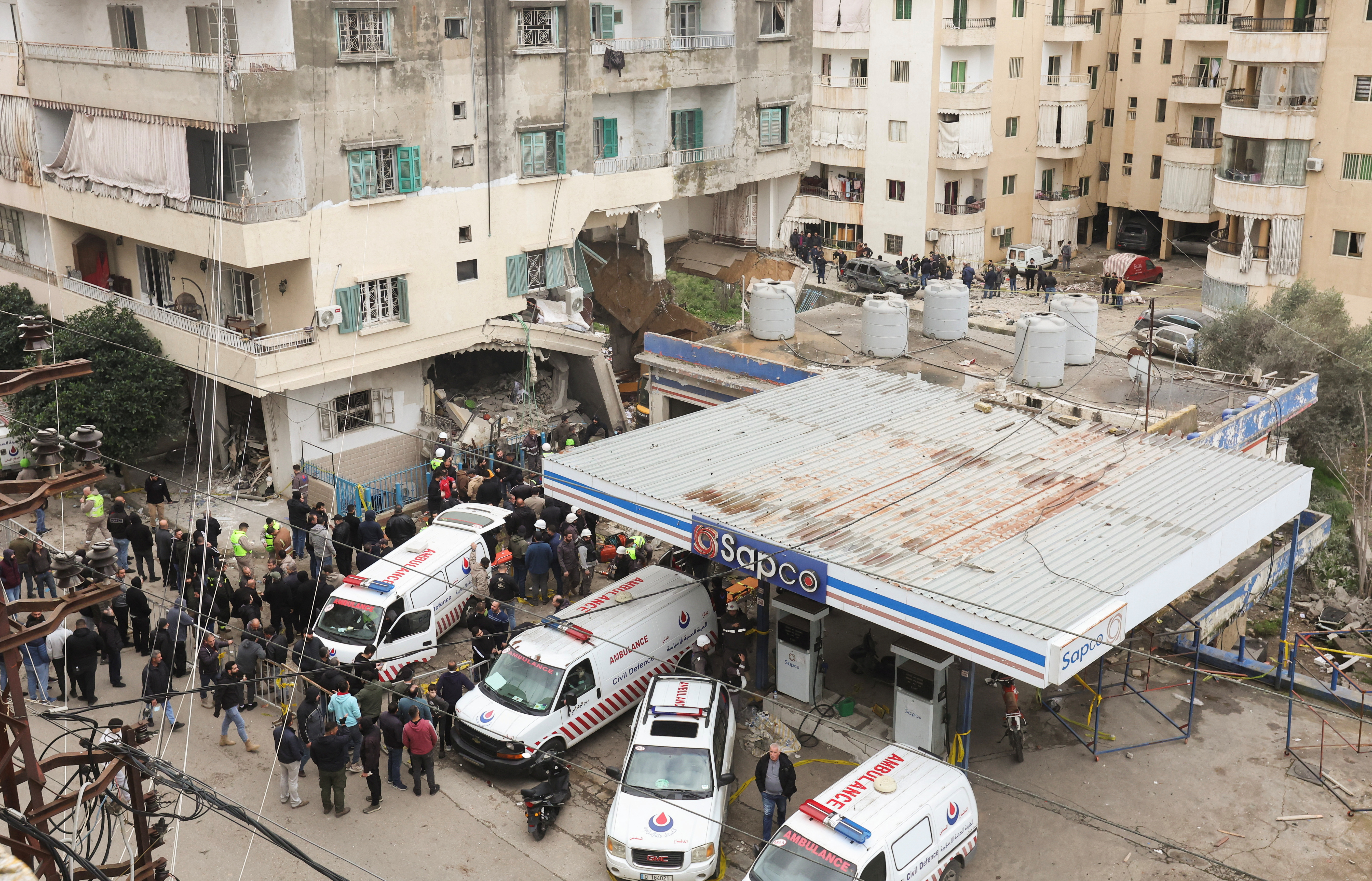 People gather near ambulances at a damaged site of what security sources said was an Israeli strike in Nabatieh./Reuters/Aziz Taher.
