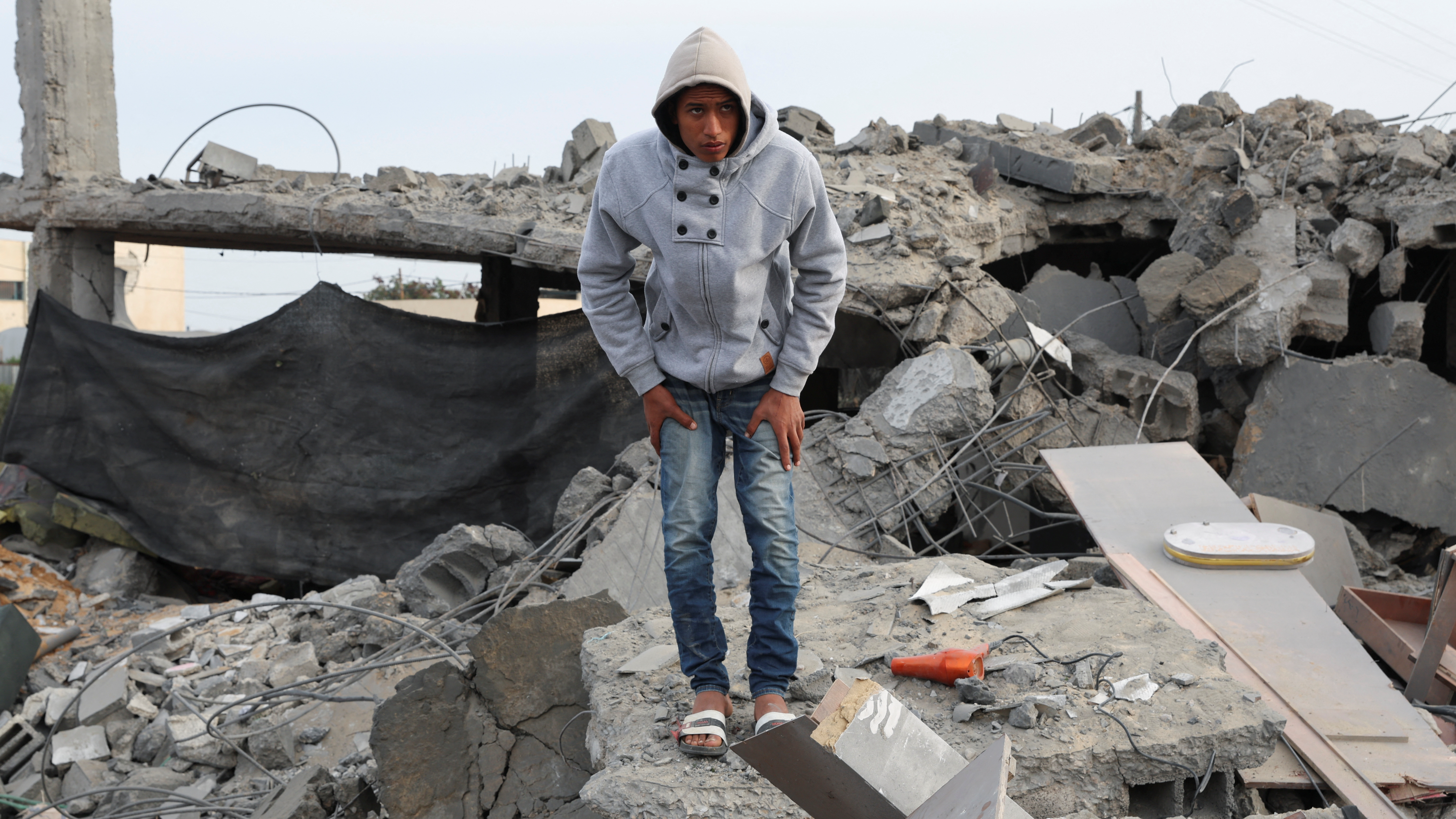 A Palestinian inspects the site of an Israeli strike on a house. /Ibraheem Abu Mustafa/Reuters