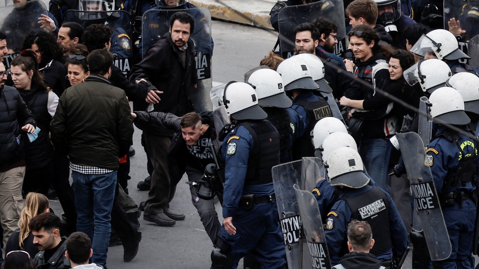 Athens police among protesters during a 24-hour strike to mark the first anniversary of a deadly train crash that killed 57 people. /Louisa Gouliamaki/Reuters