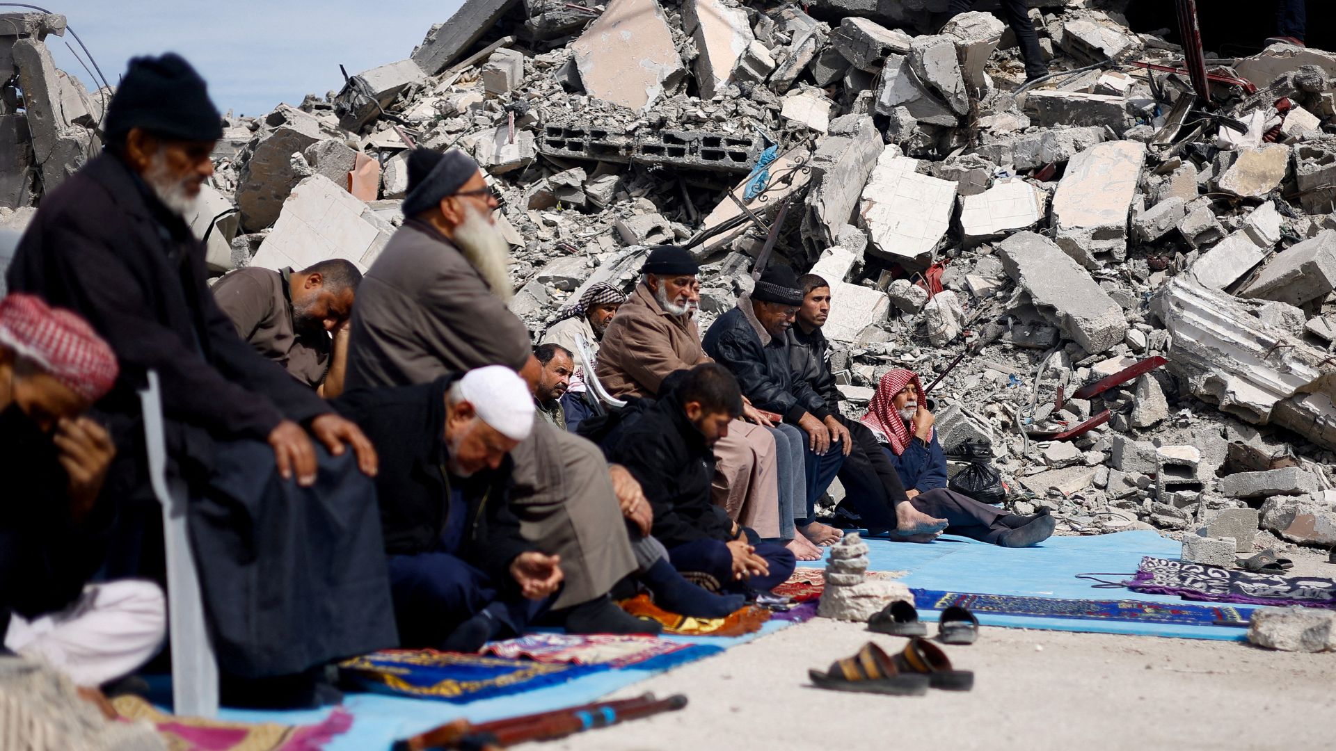 Palestinians attend Friday prayers near the ruins of a mosque destroyed in Israeli strikes in Rafah. /Mohammed Salem/Reuters
