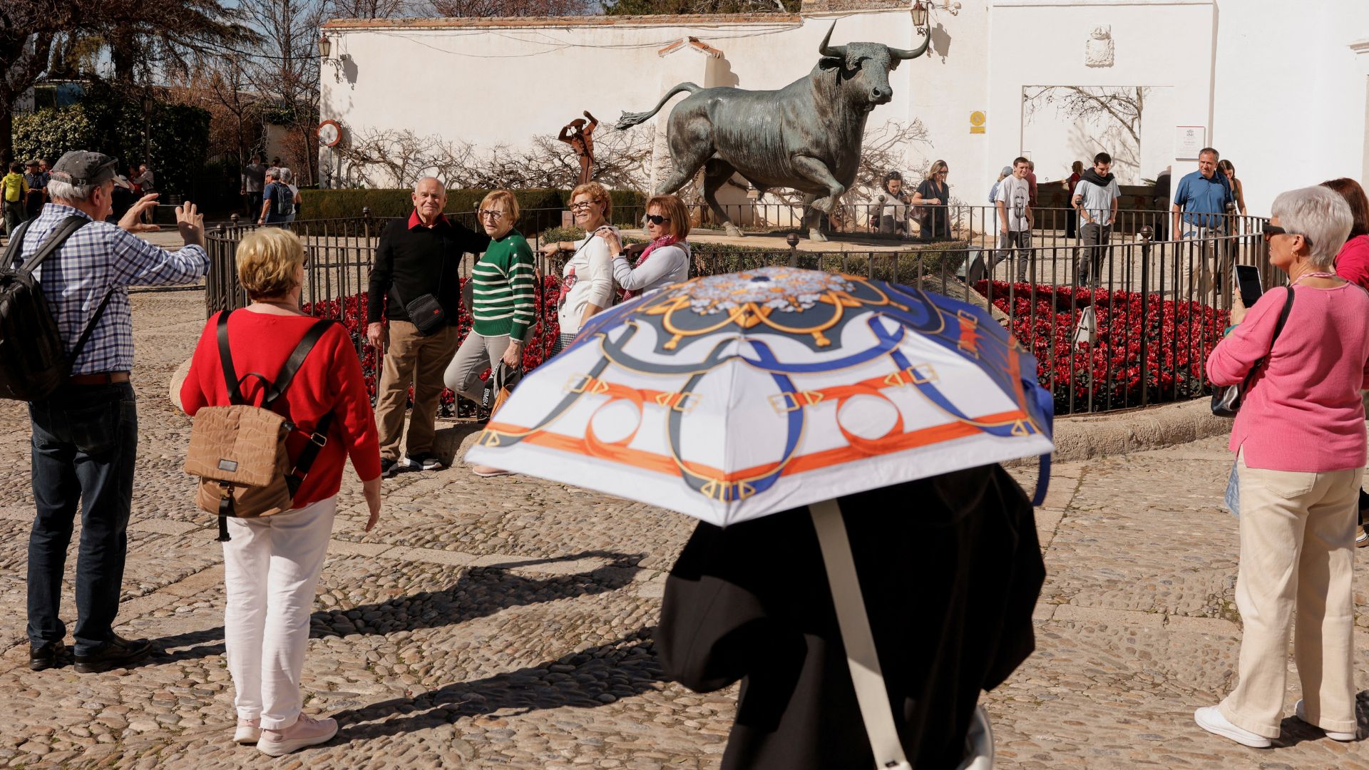 A tourist uses an umbrella to cover herself from the sun in Ronda, Spain on February 13. /Jon Nazca/Reuters