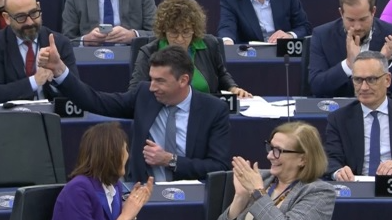 Dragos Tudorache MEP raises his thumb to salute the vote's passage. /AFP