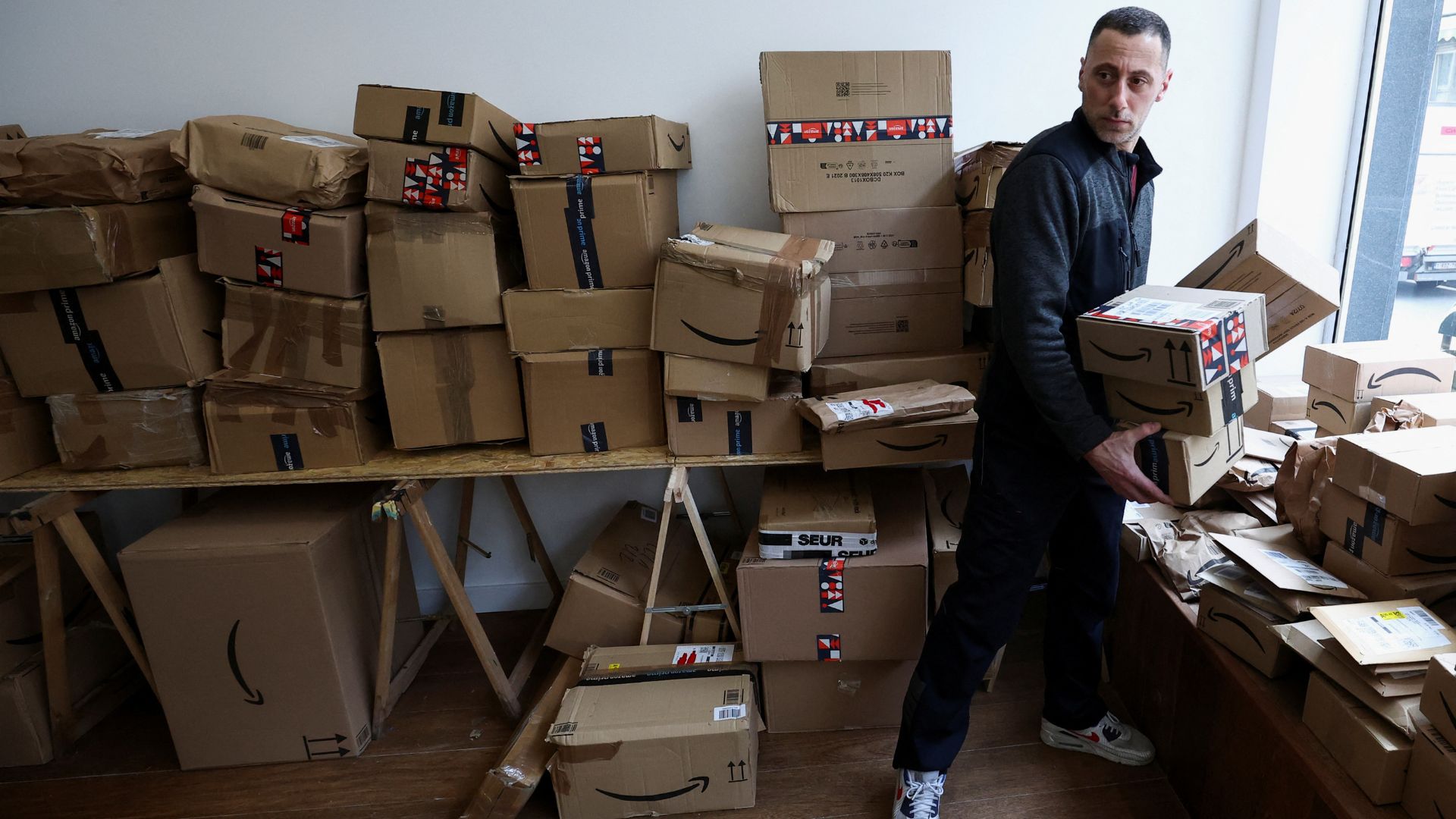 A customer chooses parcels at the 'Pile ou Face' shop. /Yves Herman/Reuters
