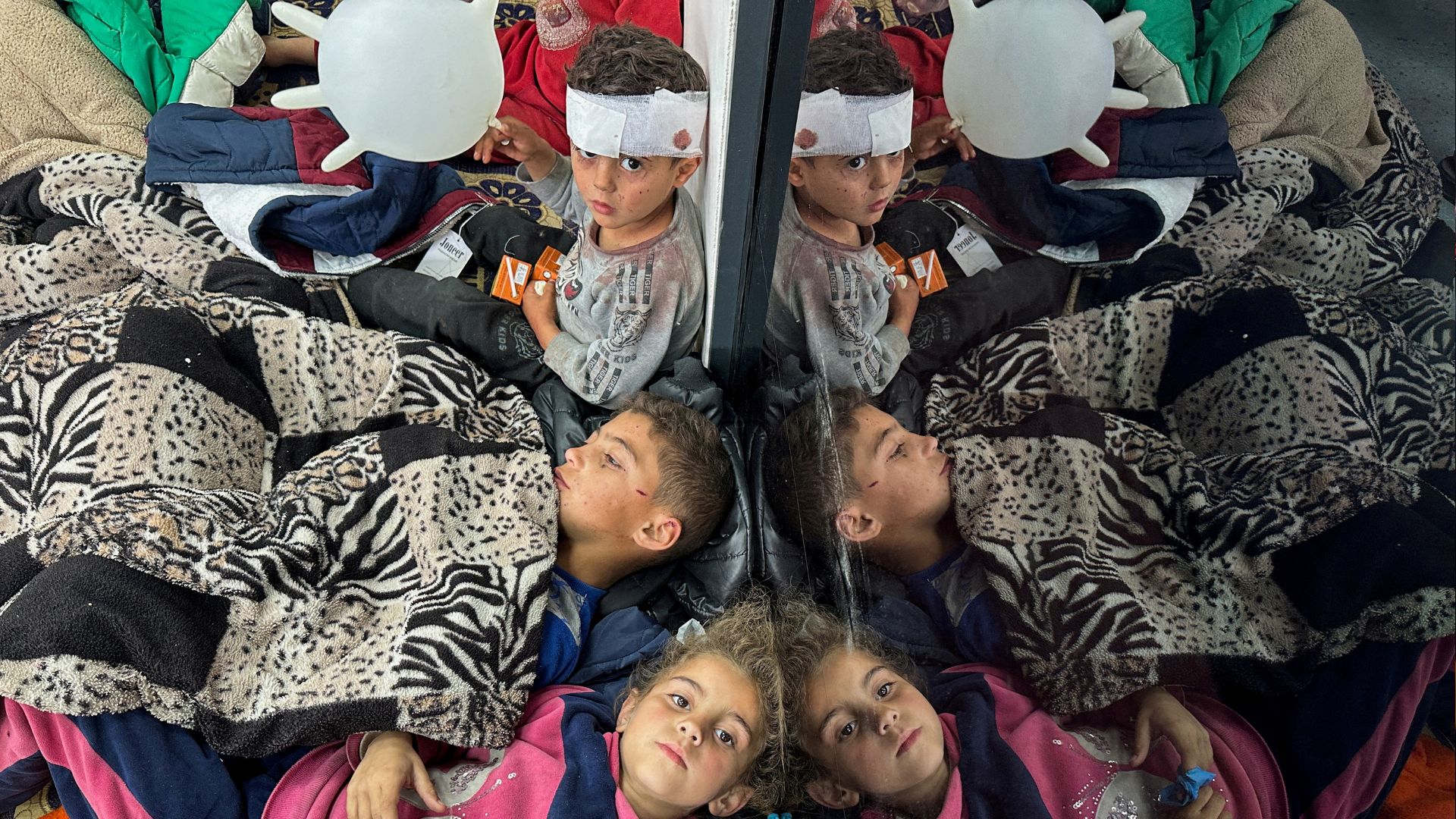 Palestinian children wounded in an Israeli strike rest as they receive treatment at a hospital. /Mohammed Salem/Reuters