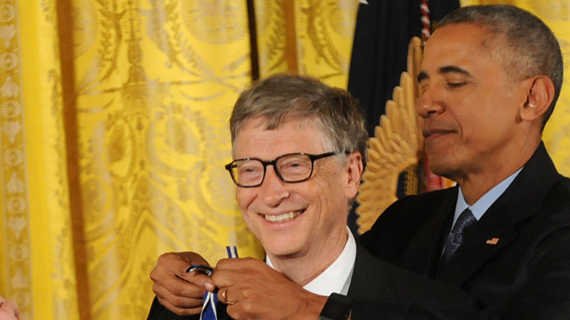 Barack Obama uses his dominant left hand to tie the ribbon of fellow southpaw Bill Gates's Medal of Freedom. /Paul Hennessy/Polaris