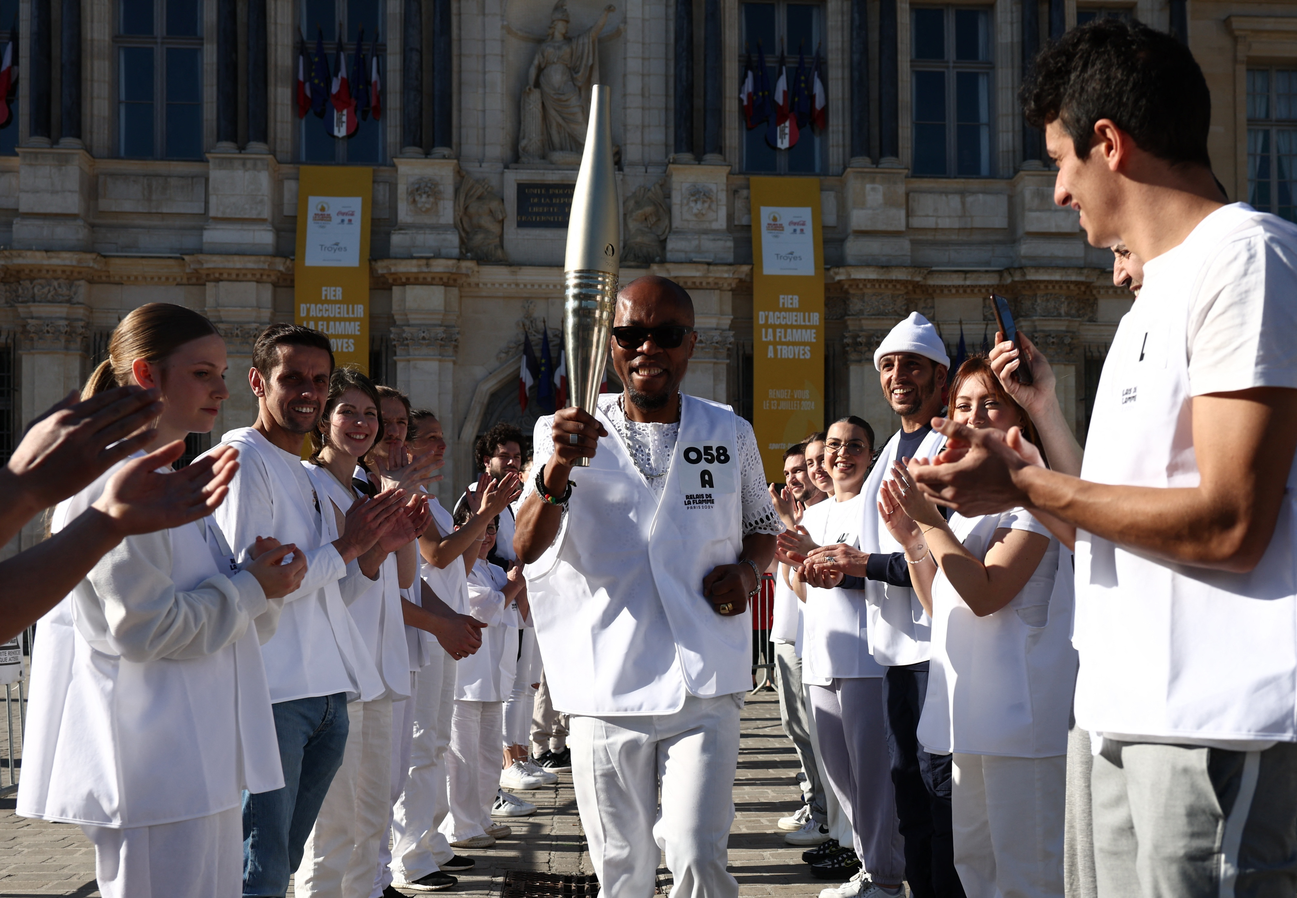 Paris 2024 volunteers perform a rehearsal for the Olympic torch relay in Troyes, France./Stephanie Lecocq/Reuters
