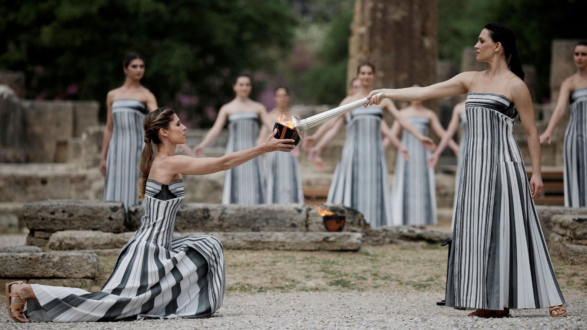 Greek actress Mary Mina, playing the role of High Priestess, lights the flame during the Olympic Flame lighting ceremony for the Paris 2024 Olympics. /Alkis Konstantinidis/Reuters