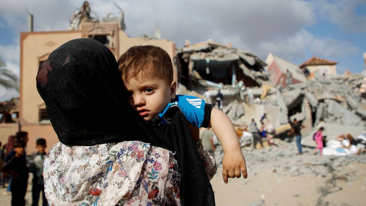 A Palestinian child looks on at the site of an Israeli strike on a house in Rafah in the southern Gaza Strip. /Hatem Khaled/Reuters