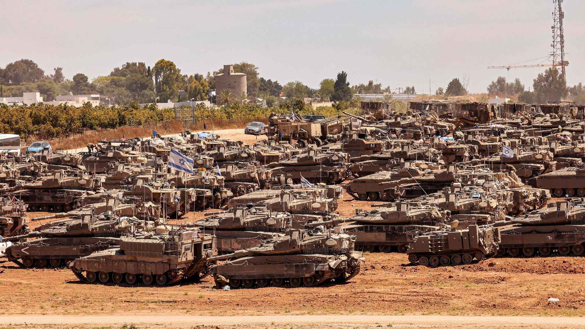 Israeli army battle tanks and military vehicles take position in southern Israel near the border with the Gaza Strip. /Jack Guez/AFP