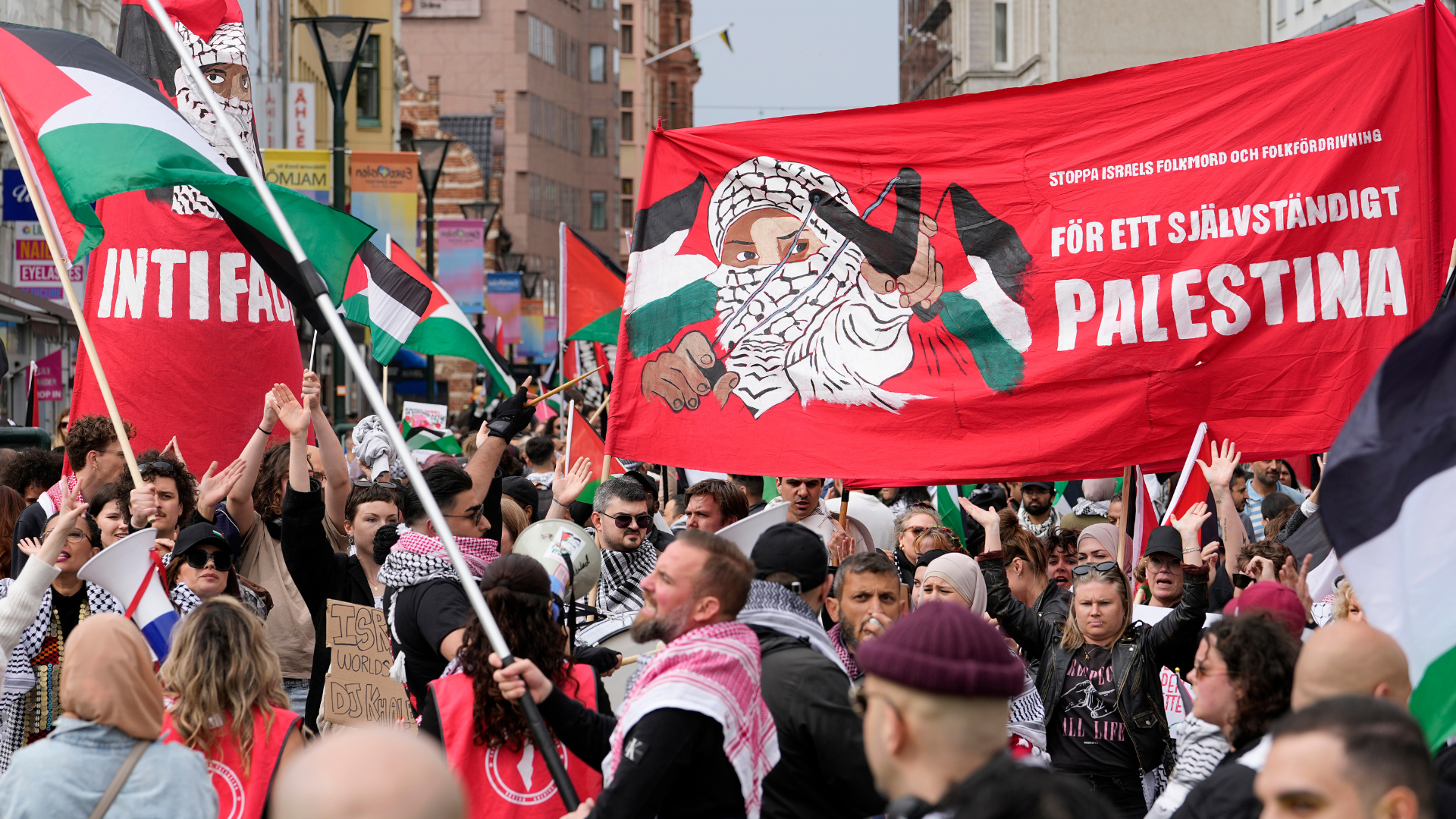 People carry a banner with the words in Swedish 'For an independent Palestine' during a Pro-Palestinian demonstration for excluding Israel from Eurovision. /Martin Meissner/AP