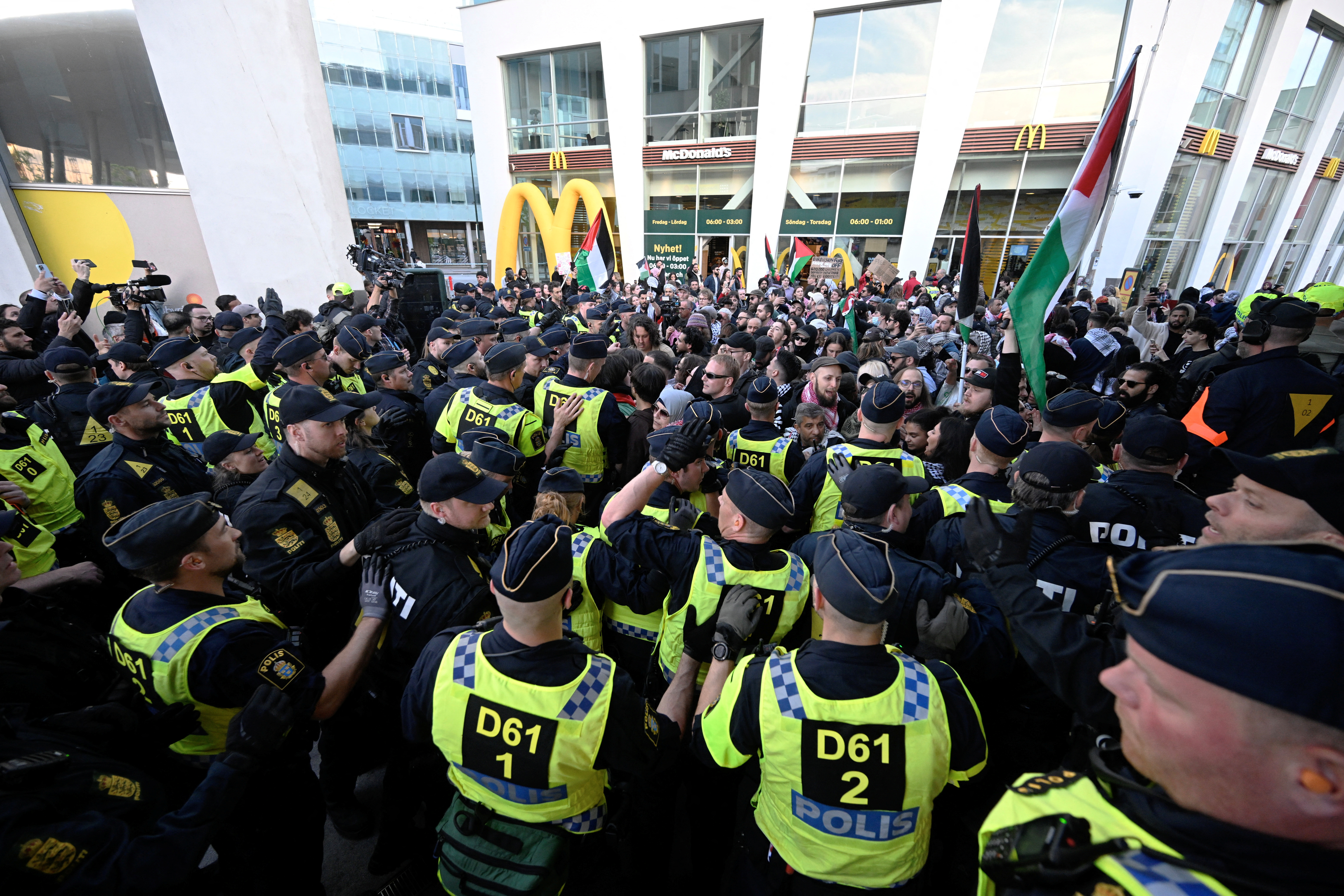 Police officers monitor protesters outside the Eurovision Song Contest. /Johan Nilsson/TT News Agency via Reuters