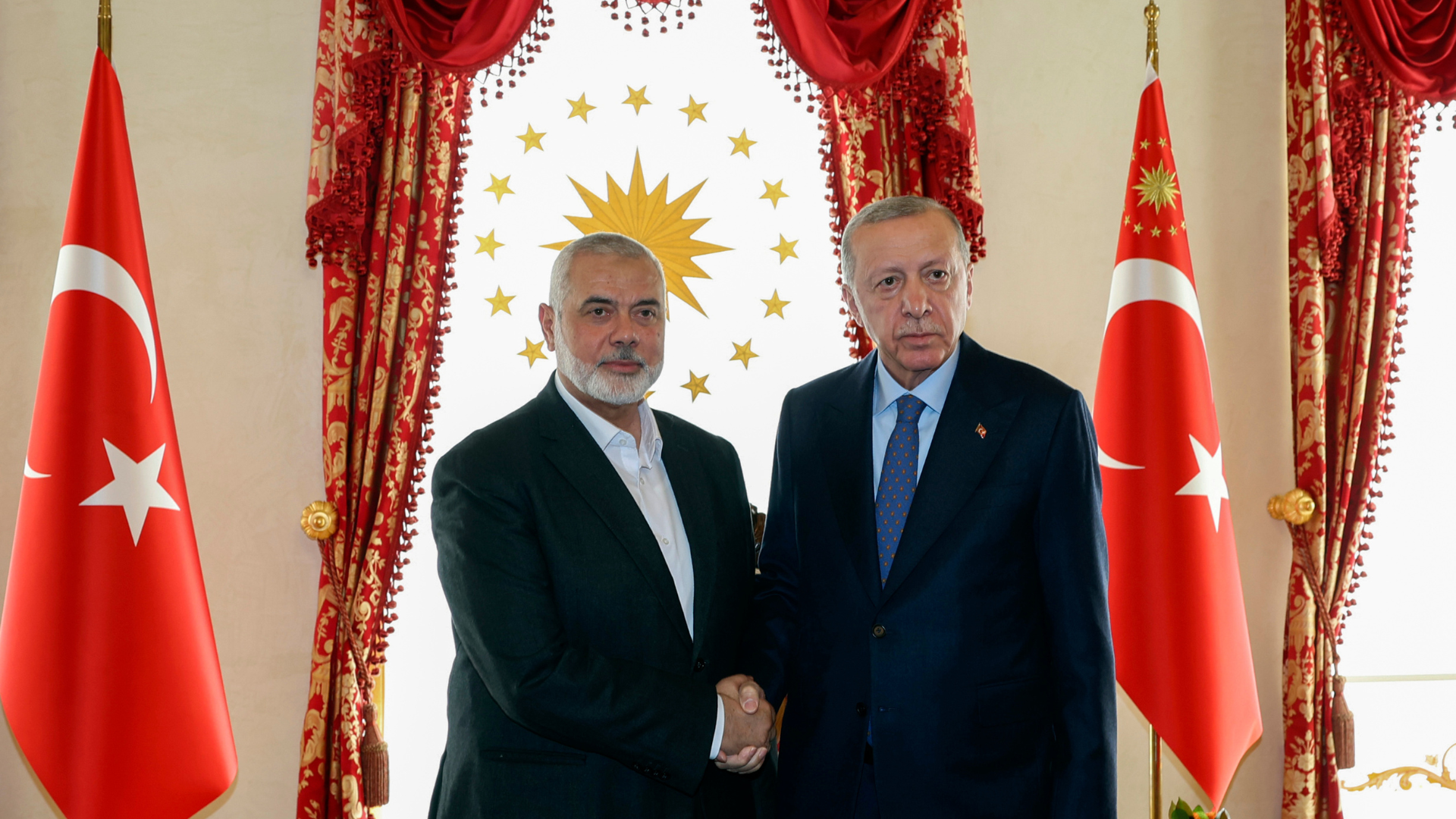 Turkey's President Recep Tayyip Erdogan, right, and Hamas leader Ismail Haniyeh, shake hands during their meeting in Istanbul. /Turkish Presidency via AP