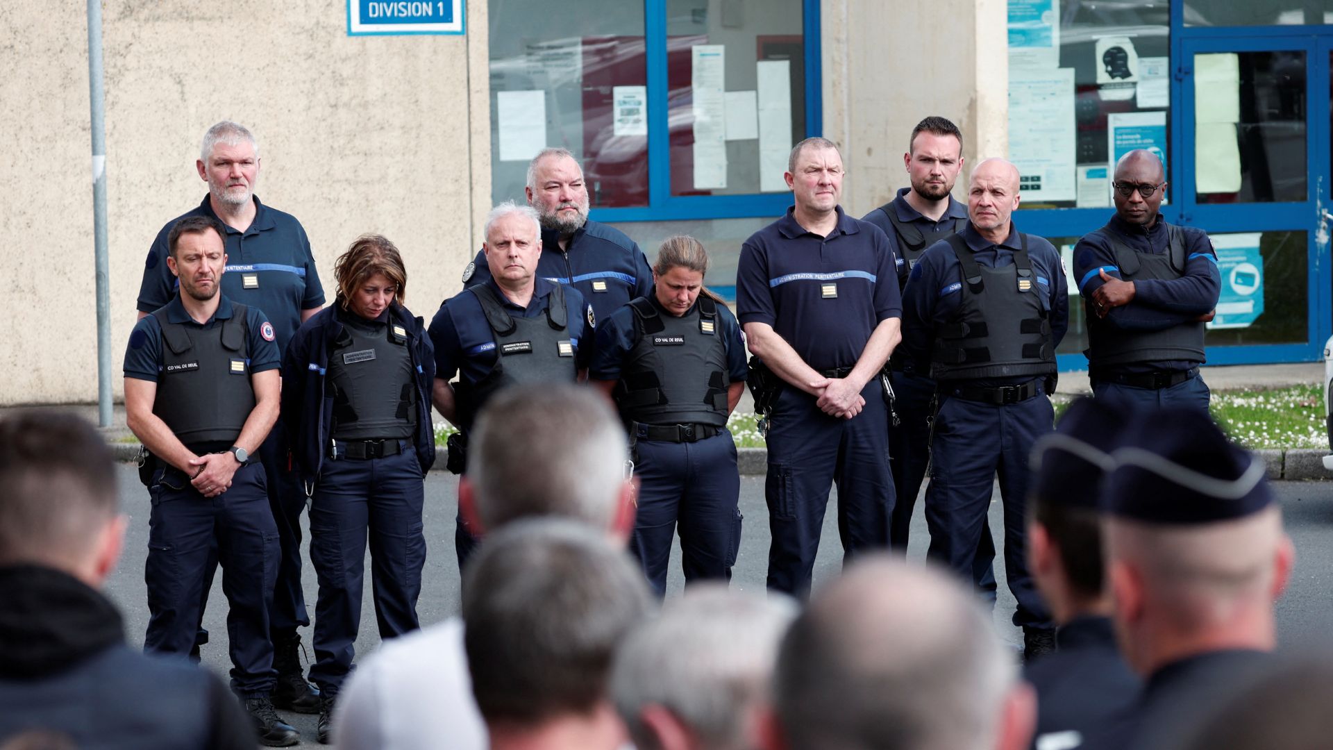 Prison staff observe a moment of silence after two prison guards were killed during a prison van escape. /Gonzalo Fuentes/Reuters