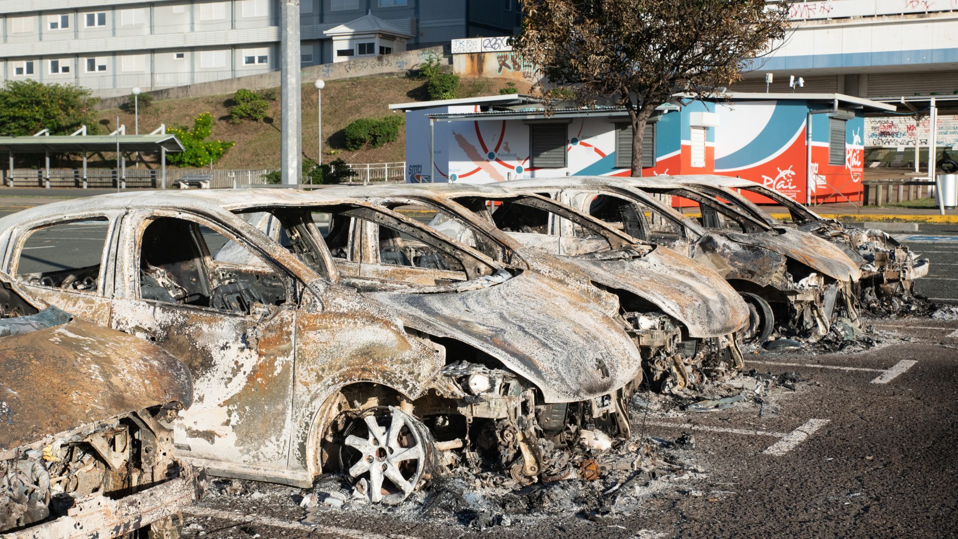 Burnt-out cars in the parking lot of the old hospital on the outskirts of Noumea. /Delphine Mayeur/AFP
