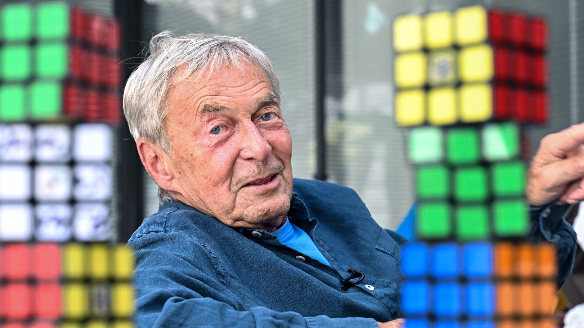 Hungarian inventor Erno Rubik sits next to several Rubik's Cubes.
/Attila Kisbenedek/AFP
